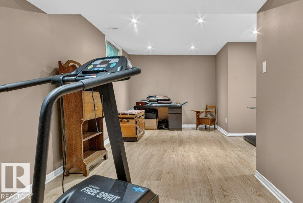Spacious room with recessed lighting, light wood-finish flooring, and neutral wall tones - 11131 35A Avenue Nw, Edmonton, AB - Indoor