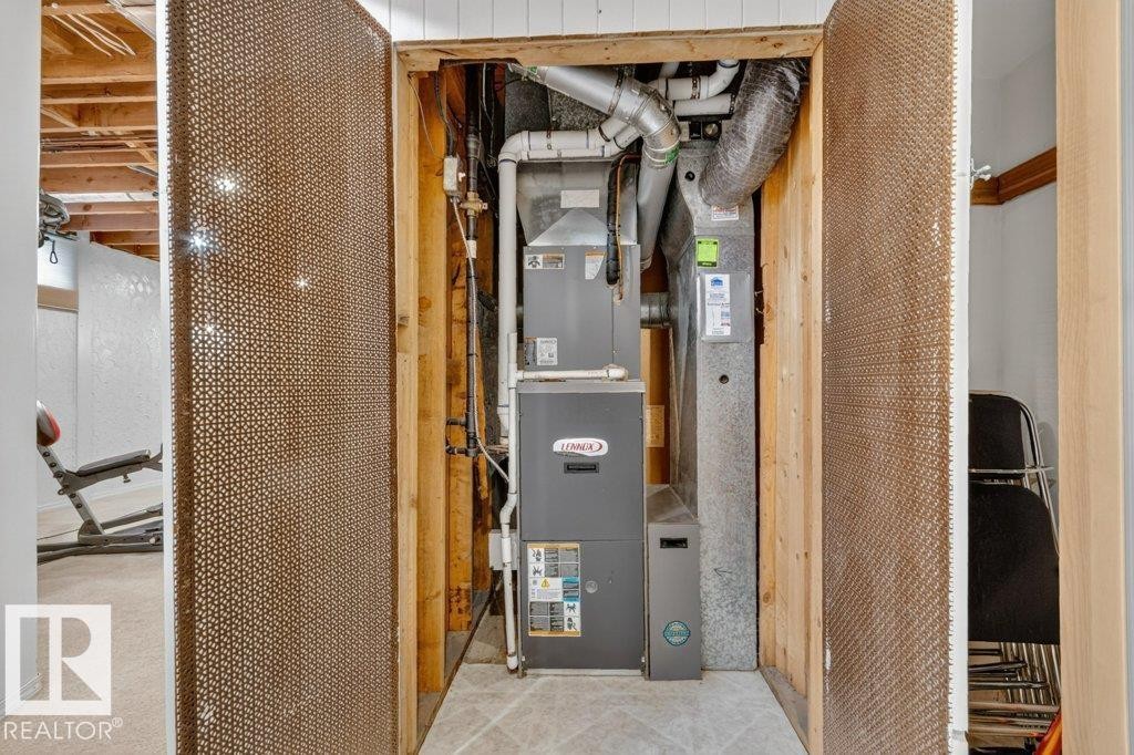 Utility closet featuring a Lennox furnace and associated ductwork - 11131 35A Avenue Nw, Edmonton, AB - Indoor