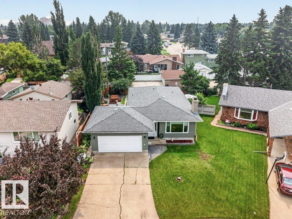 Single-story residence featuring a gray shingle roof and green siding - 11131 35A Avenue Nw, Edmonton, AB - Outdoor