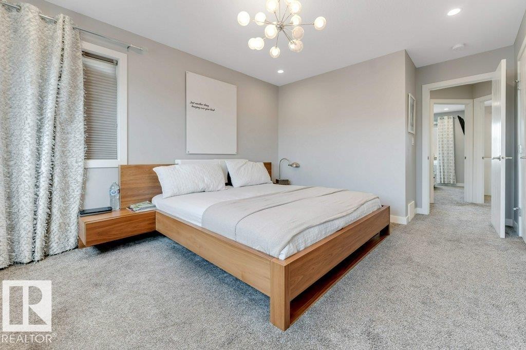 Recessed lighting, contemporary chandelier, light gray wall paint, and gray carpeted flooring - #45 16903 68 St Nw, Edmonton, AB
