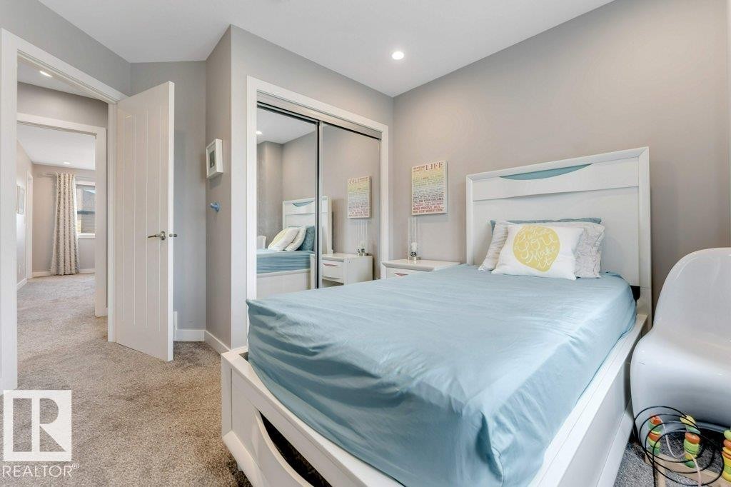 Plush carpeting, recessed lighting, and a mirrored closet door - #45 16903 68 St Nw, Edmonton, AB