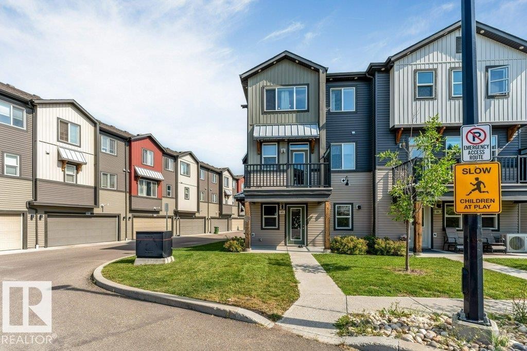Multi-level townhome featuring a private balcony and a well-maintained lawn - #45 16903 68 St Nw, Edmonton, AB