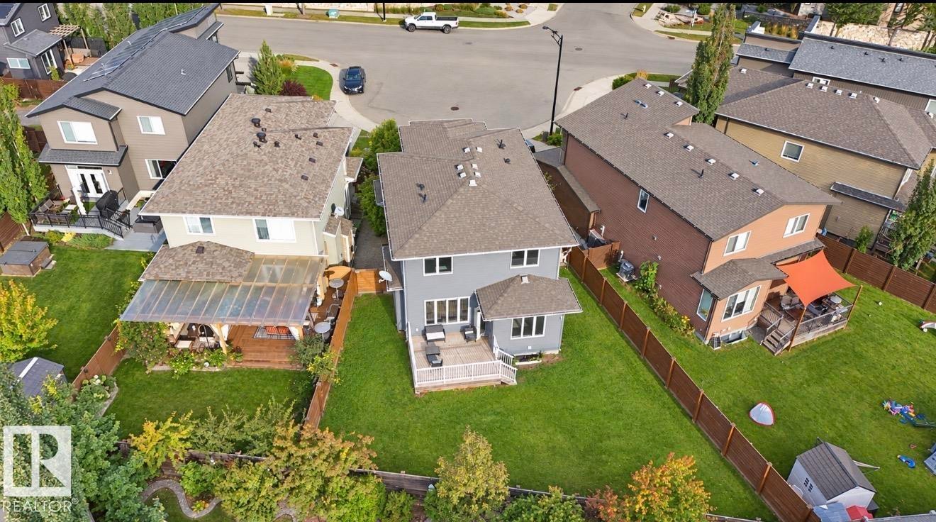 Expansive green lawn with established trees and privacy fencing - 885 Windermere Wynd Nw, Edmonton, AB