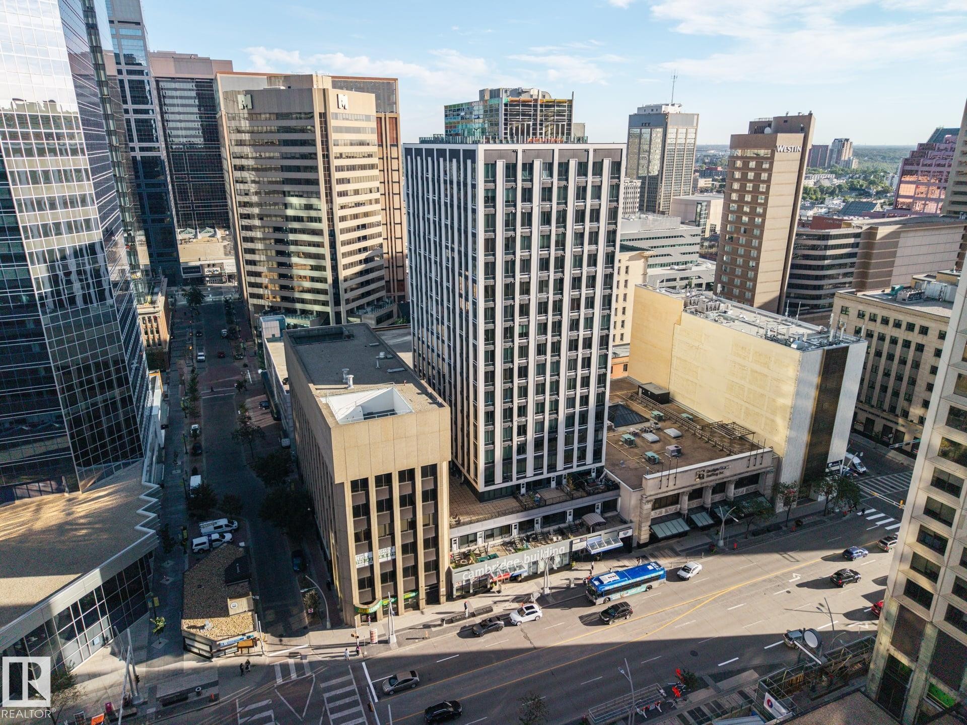 Urban landscape featuring diverse architectural styles, multi-lane roadways, and commercial buildings - #1313 10024 Jasper Av Nw, Edmonton, AB