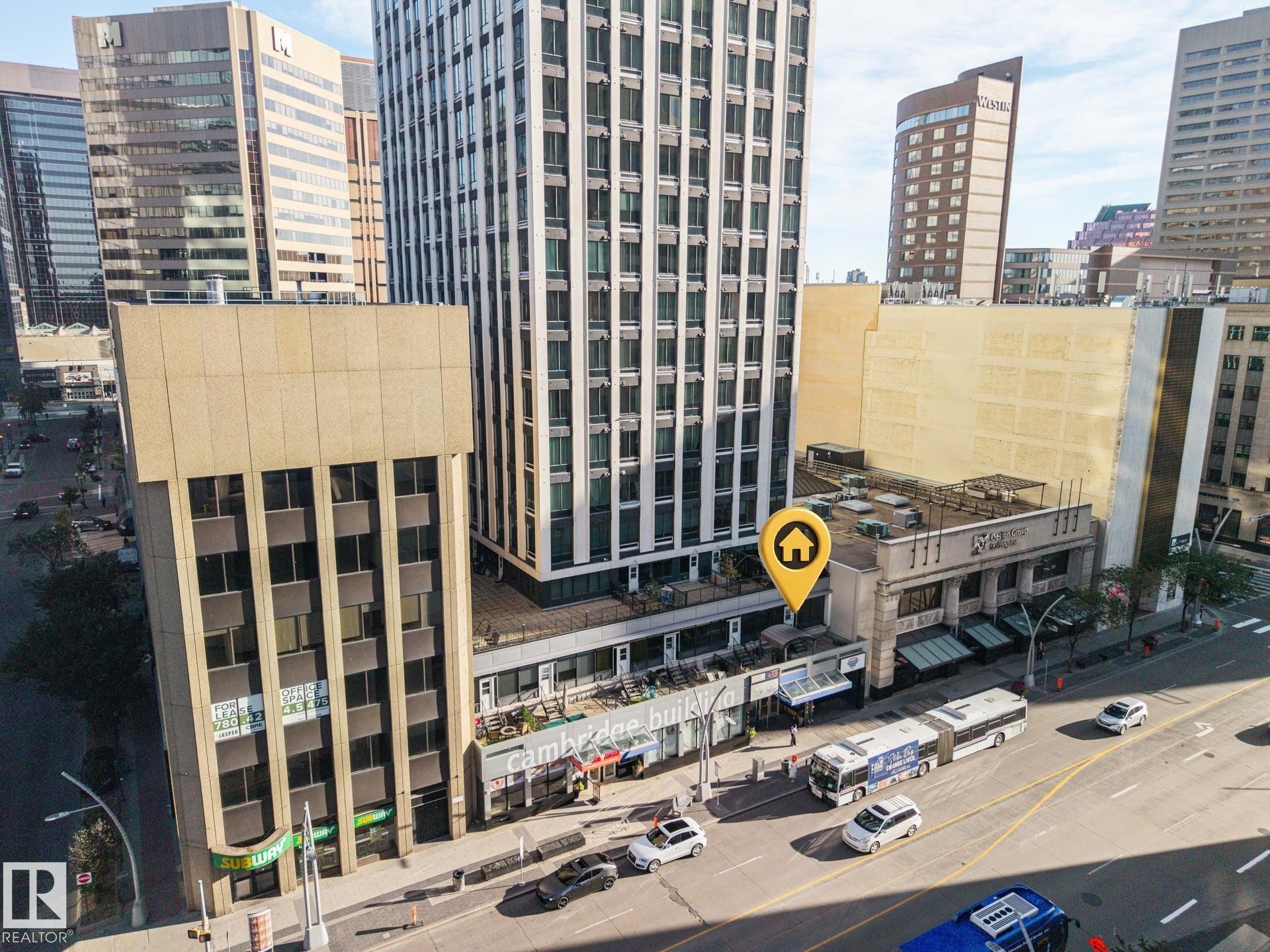 Urban setting featuring multiple high-rise buildings and street-level commercial establishments - #1313 10024 Jasper Av Nw, Edmonton, AB
