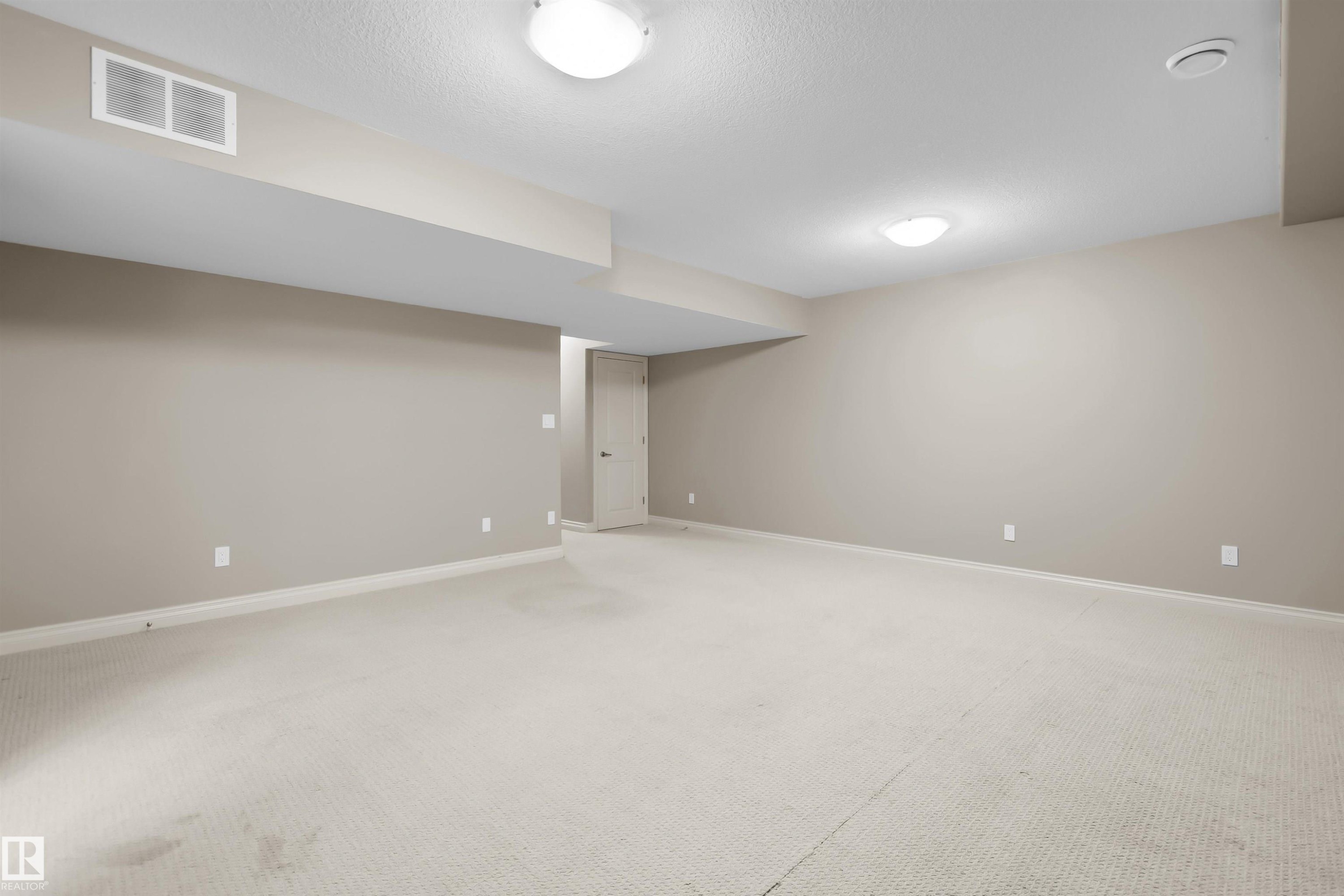 Neutral-toned walls with contrasting white trim, recessed lighting, and light-colored carpet - #5 5120 164 Av Nw, Edmonton, AB