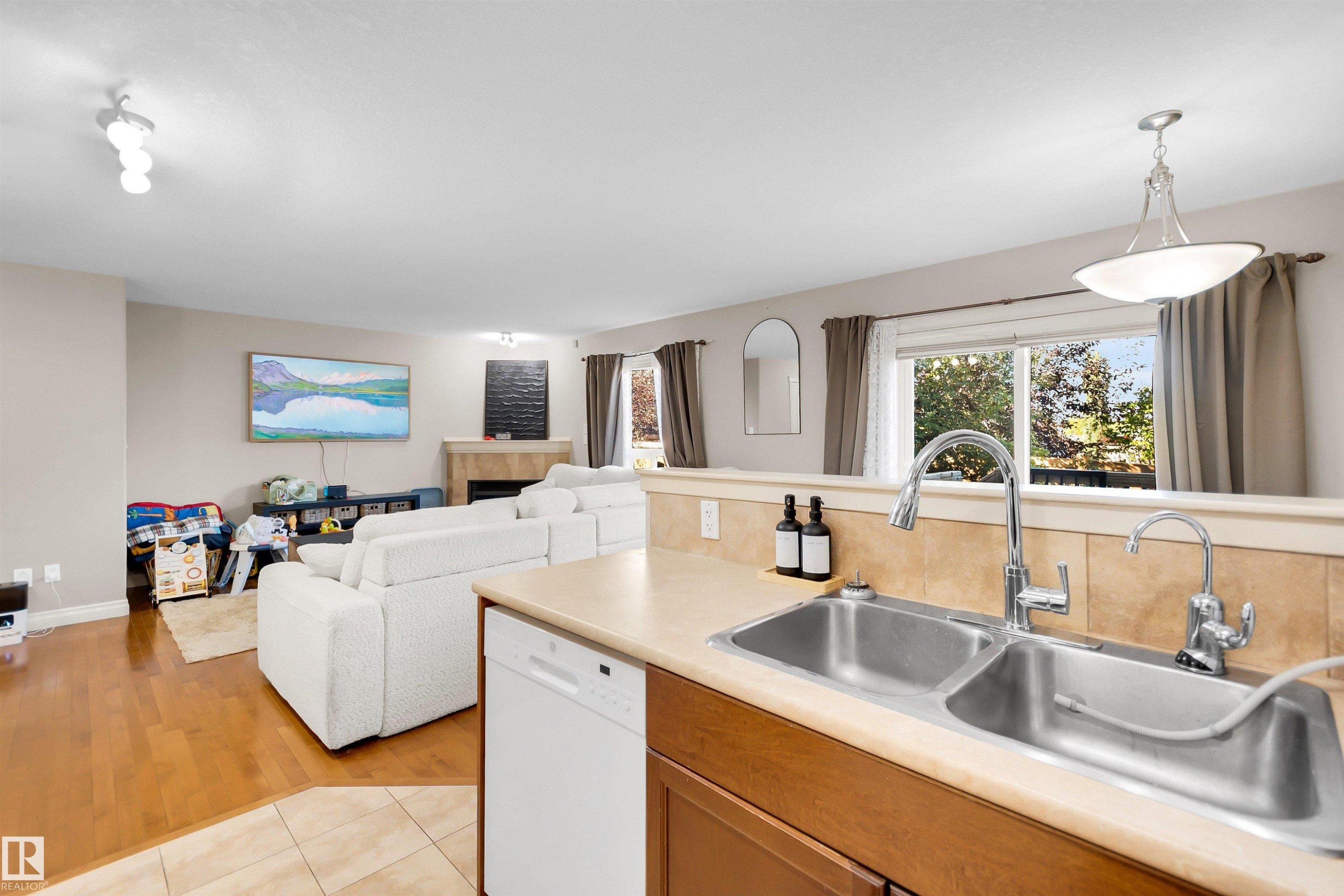 Kitchen sink with a chrome faucet, dual basin, and a light-colored countertop - #5 5120 164 Av Nw, Edmonton, AB