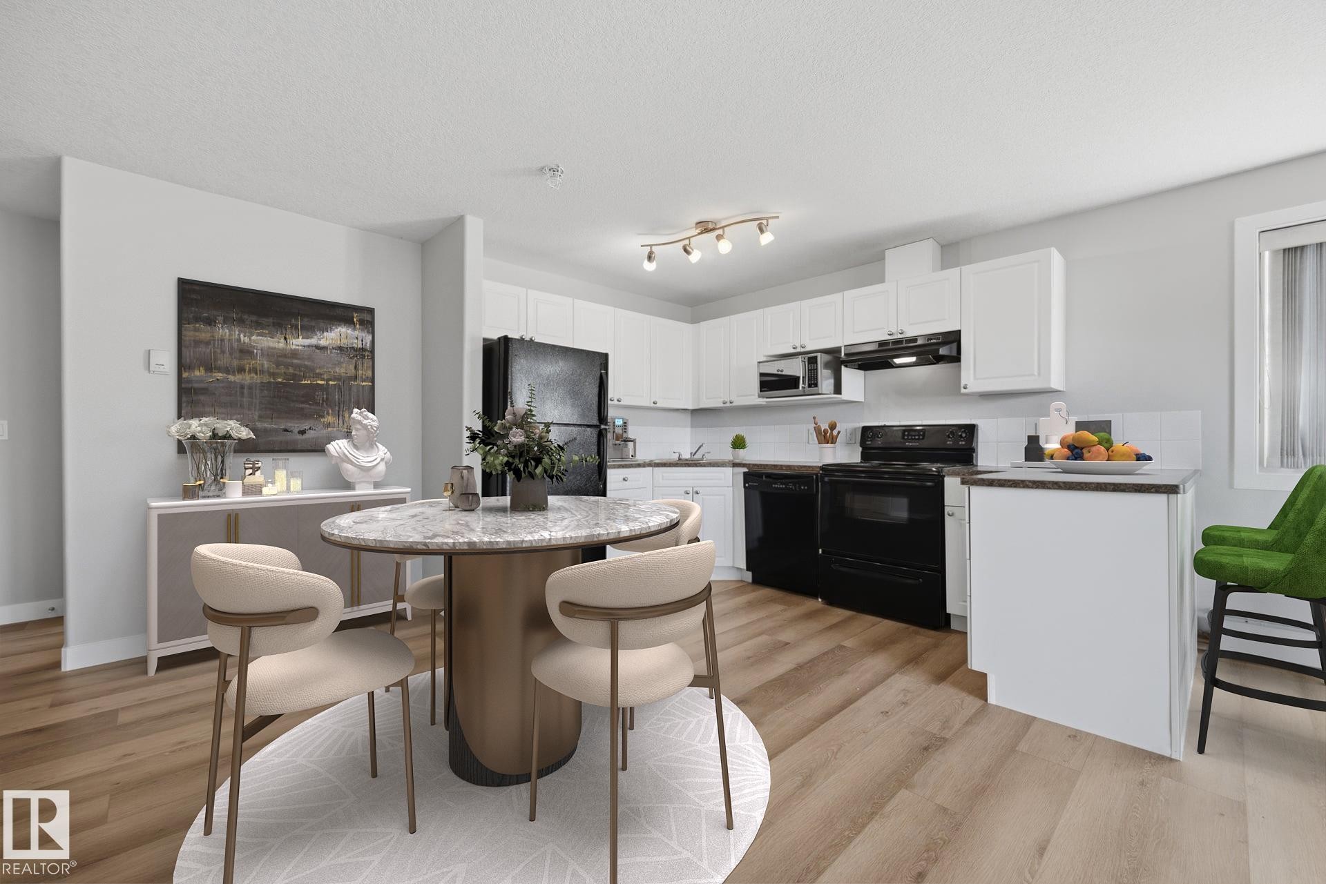 Open-concept kitchen featuring wood-finish flooring, white cabinetry, black appliances, track lighting, and a breakfast bar - #122 240 Spruce Ridge Rd, Spruce Grove, AB