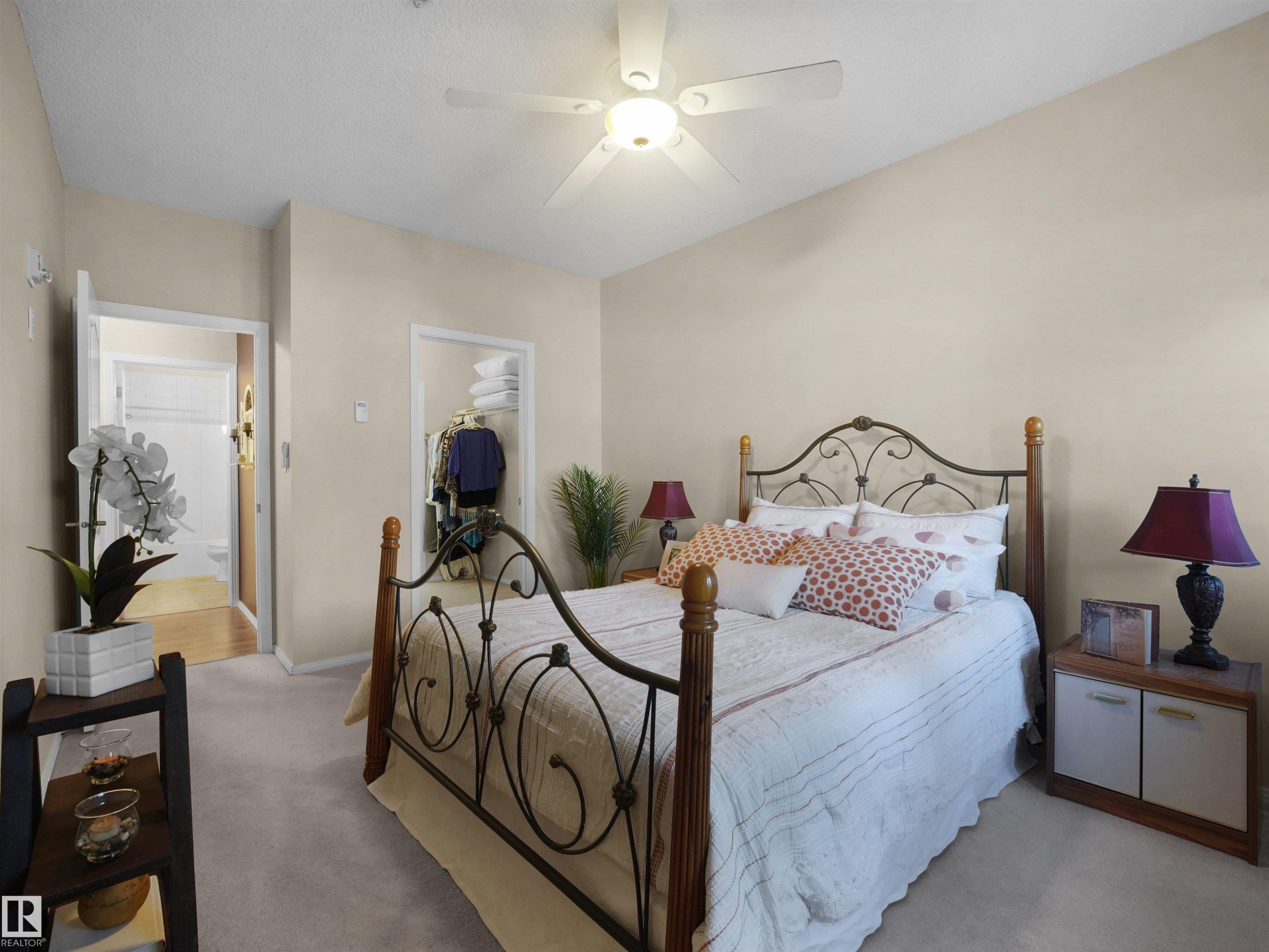 Vaulted ceiling, ceiling fan, carpet flooring, open closet, and open doorway - #206 12111 51 Av Nw, Edmonton, AB