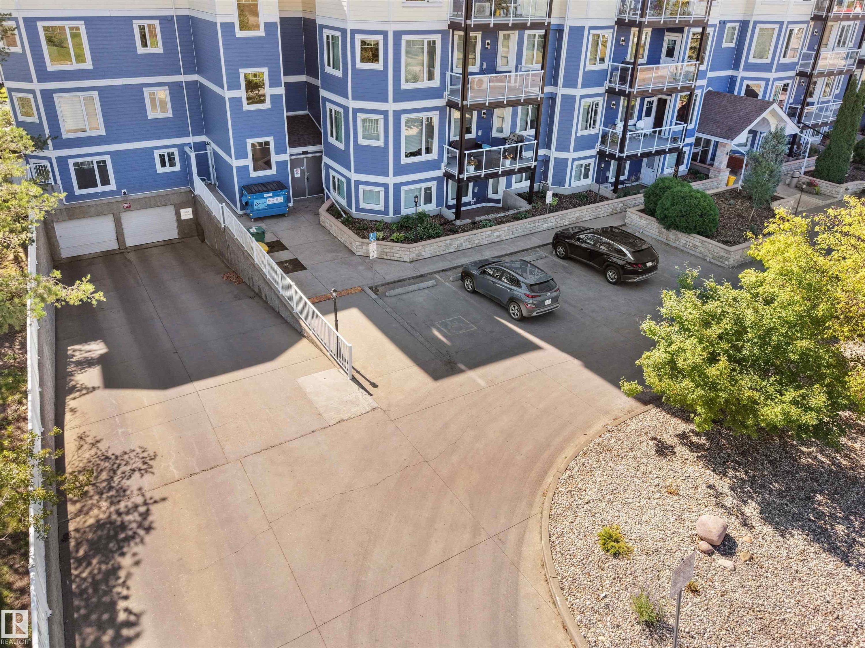 Multi-story building with blue siding and white trim - #206 12111 51 Av Nw, Edmonton, AB