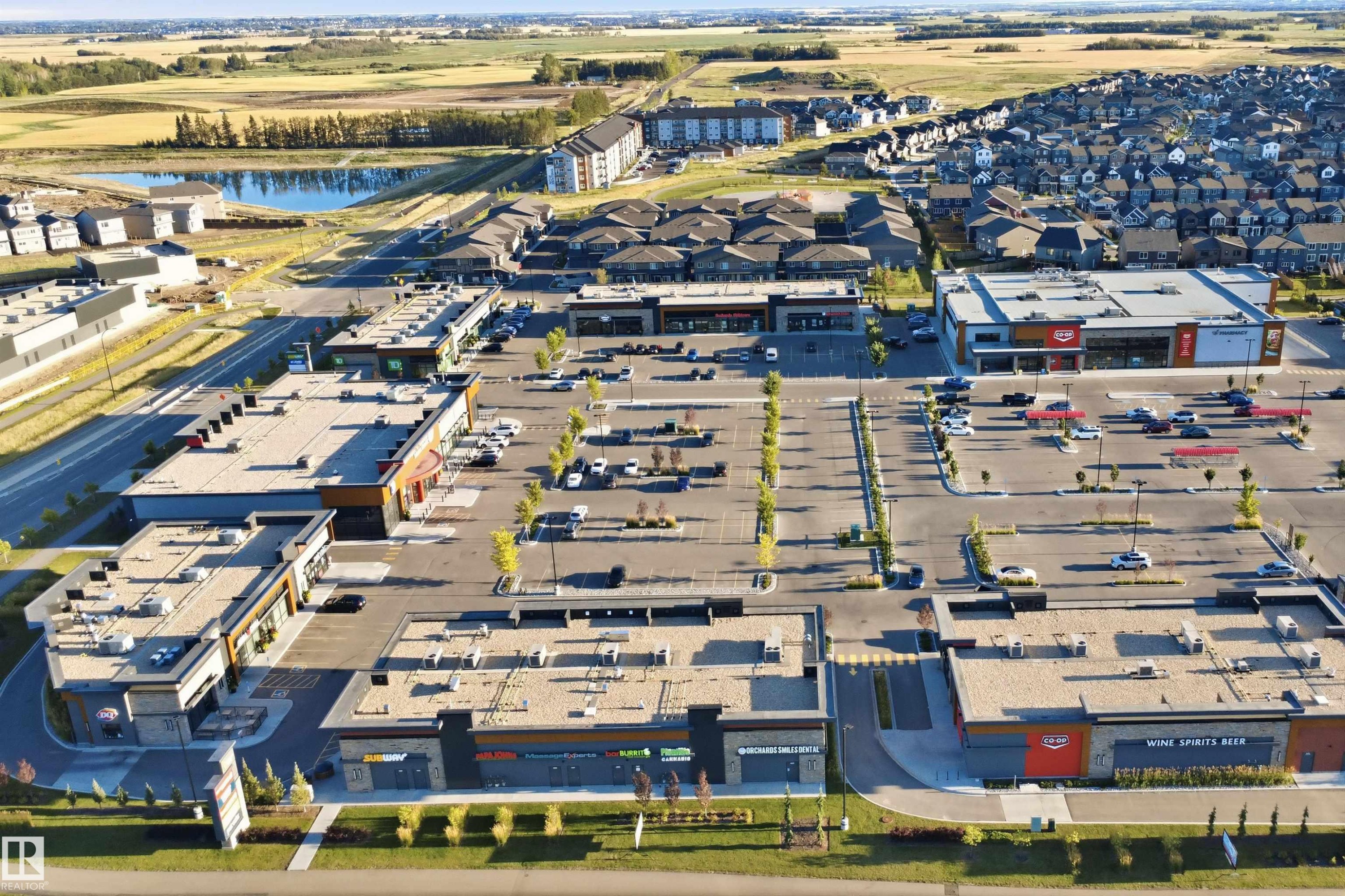 Aerial perspective showcasing multiple commercial buildings with ample surface parking - #225 1510 Watt Dr Sw, Edmonton, AB