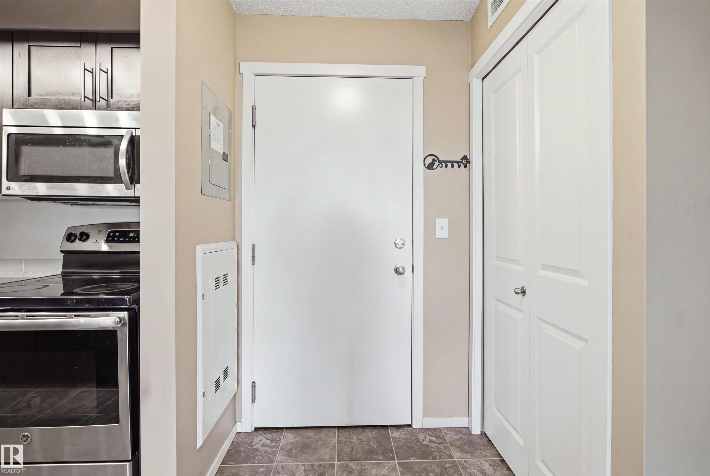 Stainless steel microwave, stainless steel range, and wood-finish cabinetry - #225 1510 Watt Dr Sw, Edmonton, AB
