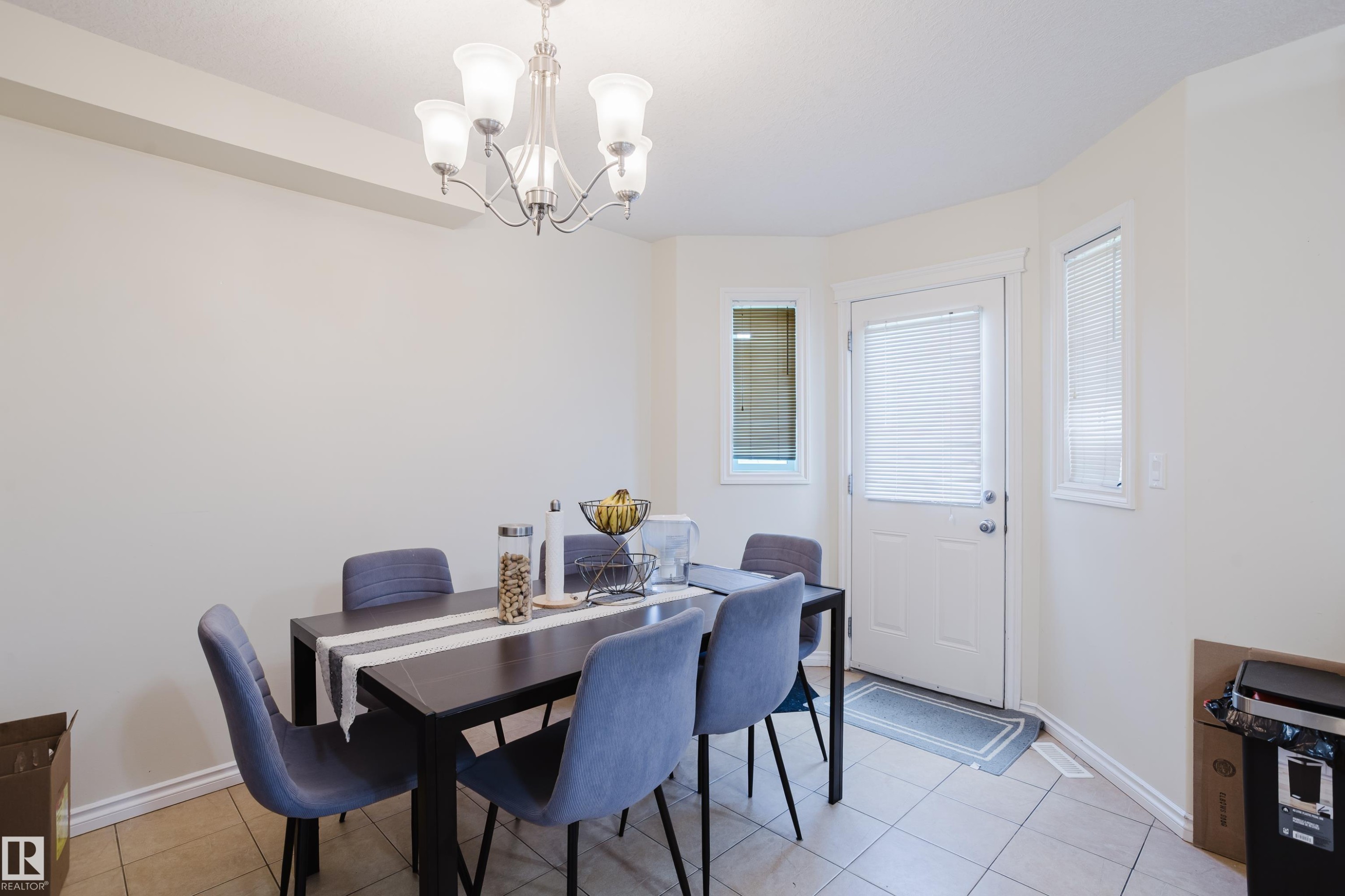 Recessed ceiling beam, five-light chandelier, white door with blinds, and white window trim - 10332 161 Street Nw, Edmonton, AB