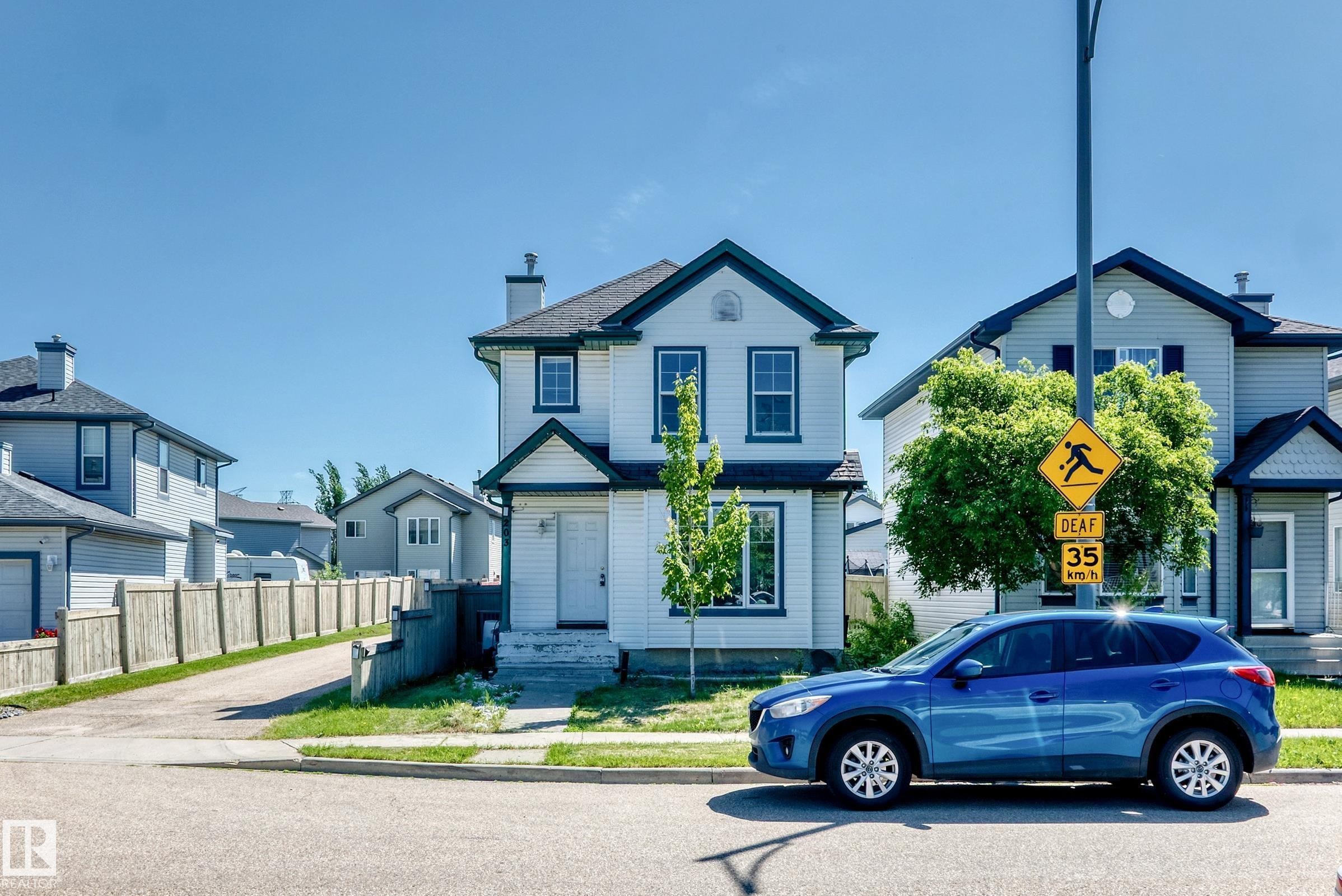 White two-story residence featuring dark trim and a gabled roofline - 203 84 Street Sw, Edmonton, AB - Outdoor With Facade