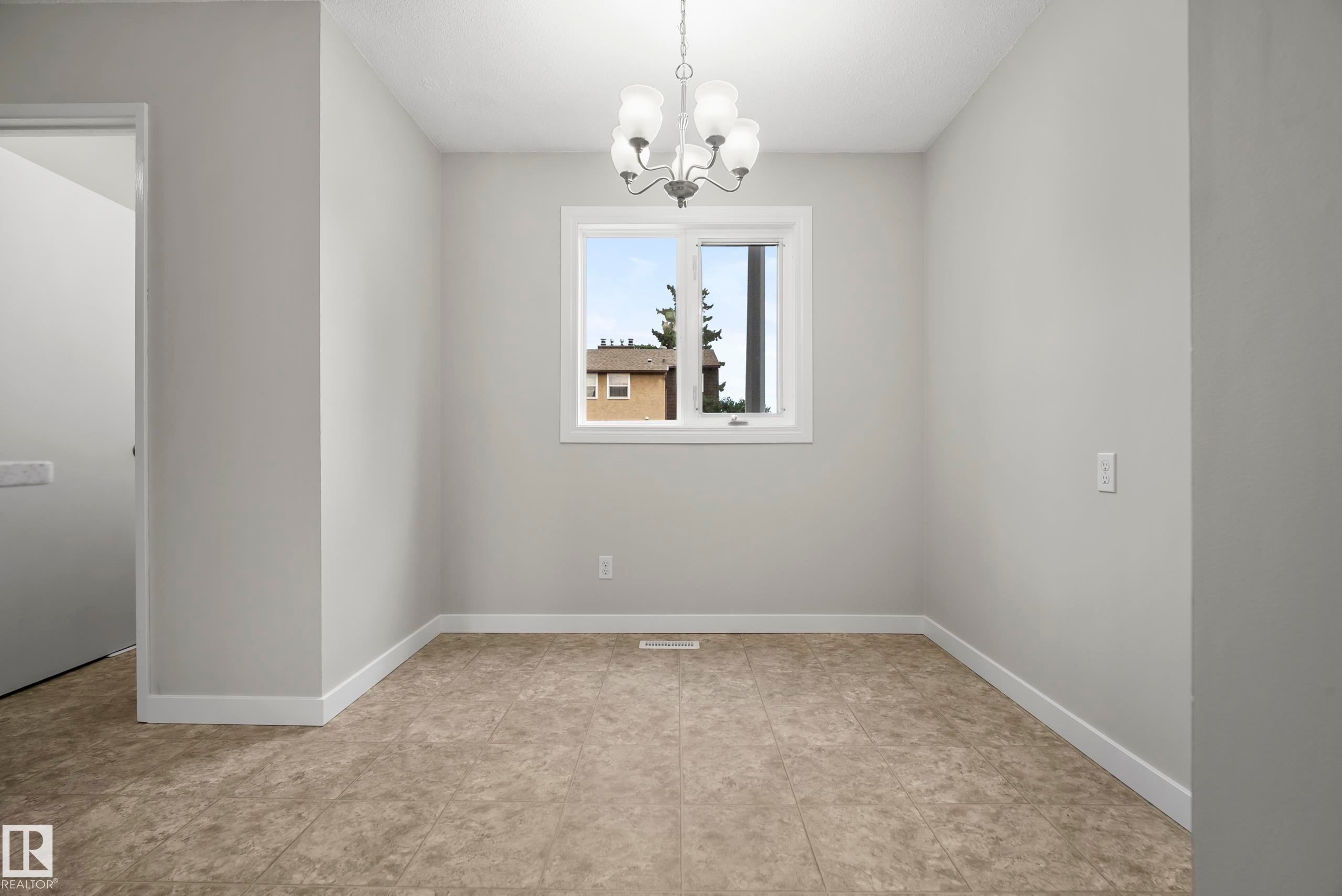 Recessed window, chandelier lighting, light-toned walls, tile flooring, and white trim - 3173 139 Avenue Nw, Edmonton, AB