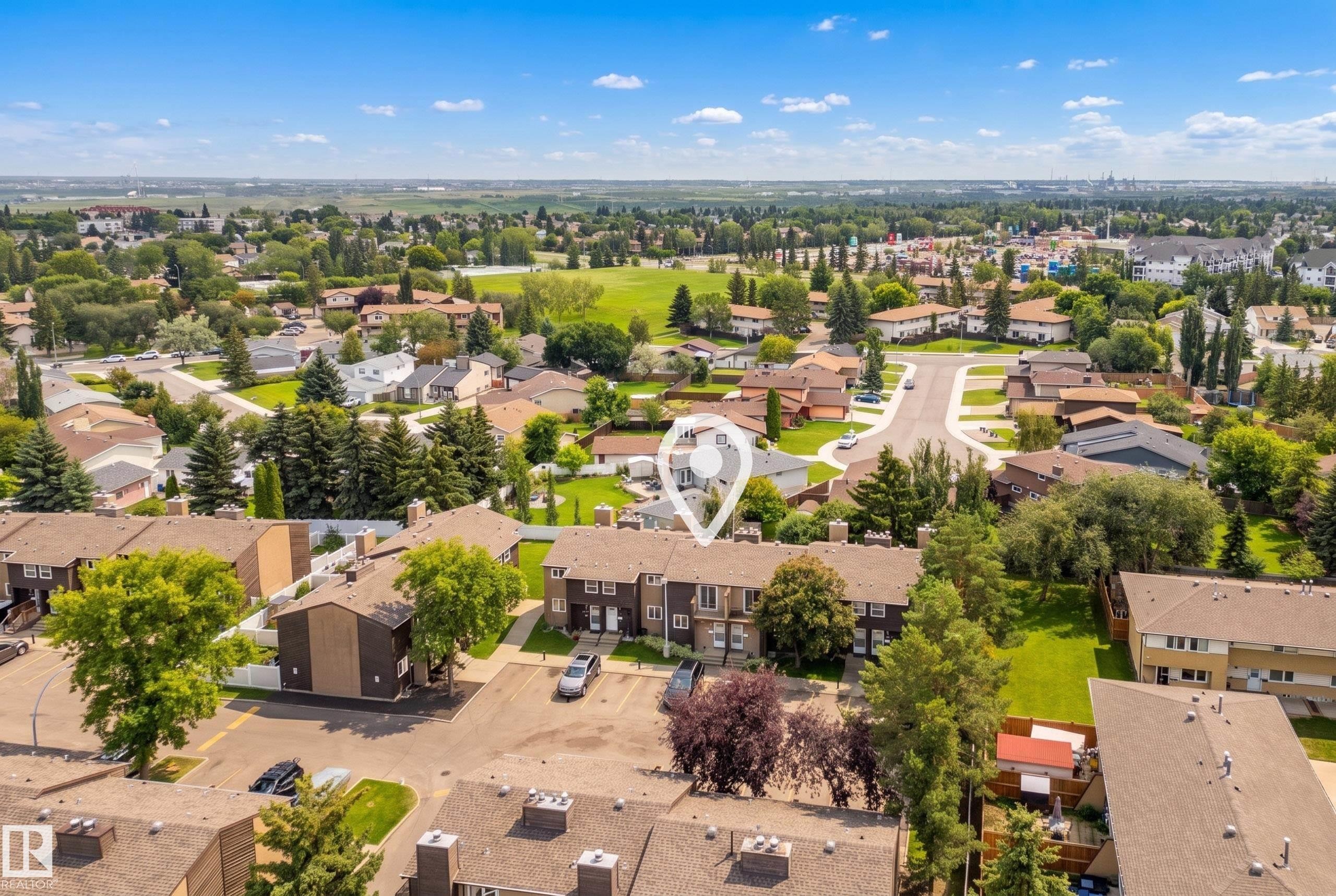 Aerial perspective showcasing a residential community with mature trees and green spaces - 3173 139 Avenue Nw, Edmonton, AB