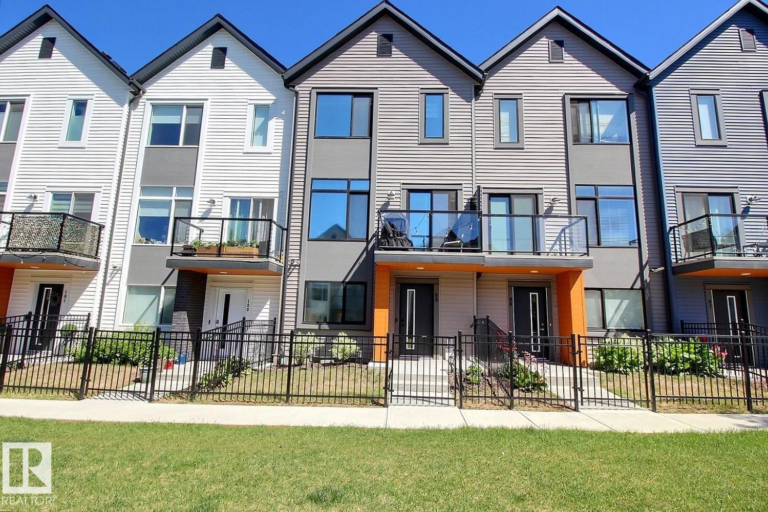 Modern townhome exterior featuring contemporary grey siding and crisp white trim - #99 1010 Rabbit Hill Rd Sw, Edmonton, AB