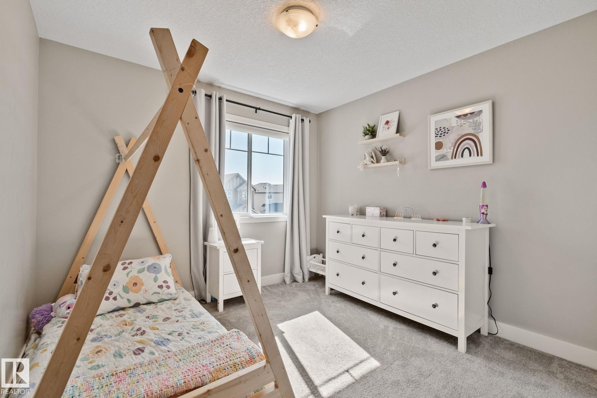 Carpeted flooring, neutral wall tones, recessed window, ceiling-mounted light fixture, and shelving - 2096 Redtail Common Nw, Edmonton, AB