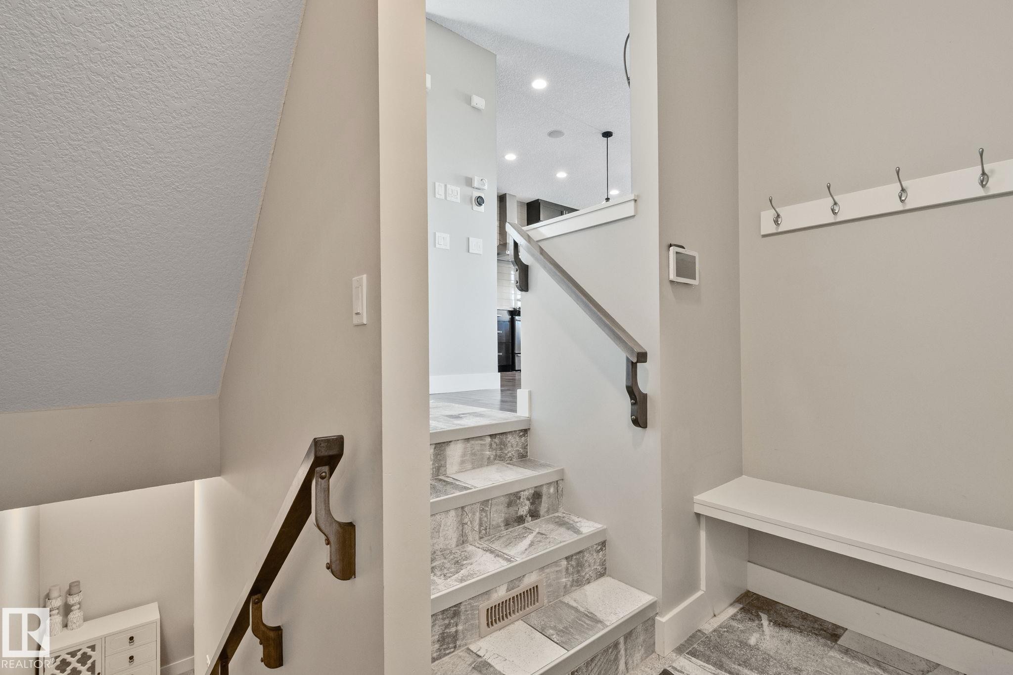 Built-in hall tree with bench seating and coat hooks - 2096 Redtail Common Nw, Edmonton, AB
