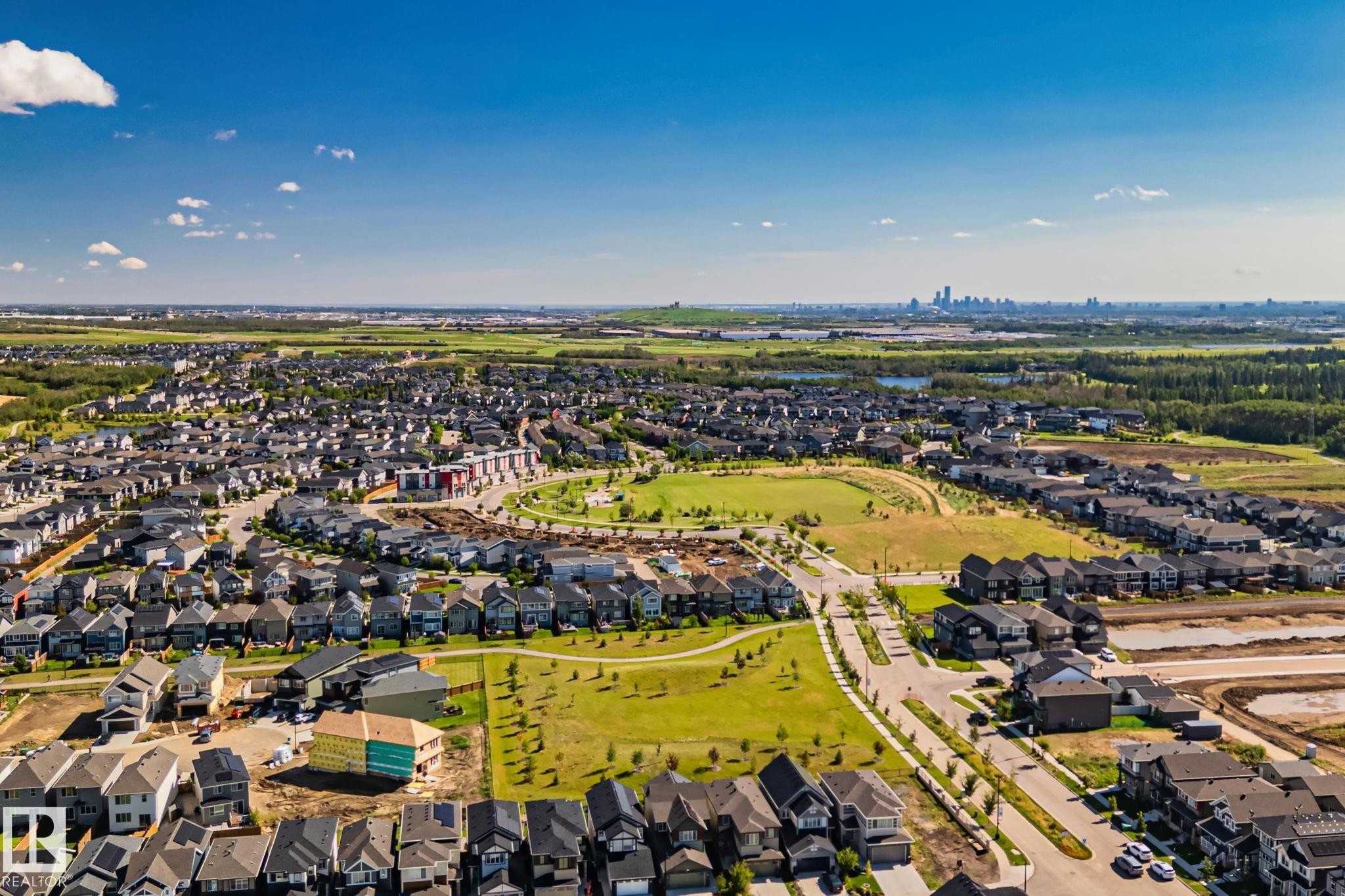 Expansive residential neighborhood featuring numerous single-family homes, wide paved streets, and abundant green spaces - 2096 Redtail Common Nw, Edmonton, AB