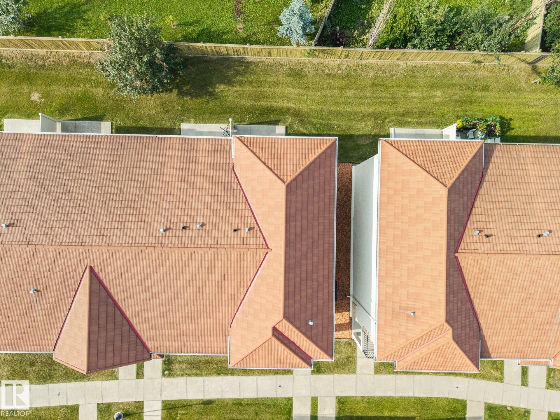Terracotta-toned tile roofing across multiple structures - #102 13825 155 Av Nw, Edmonton, AB