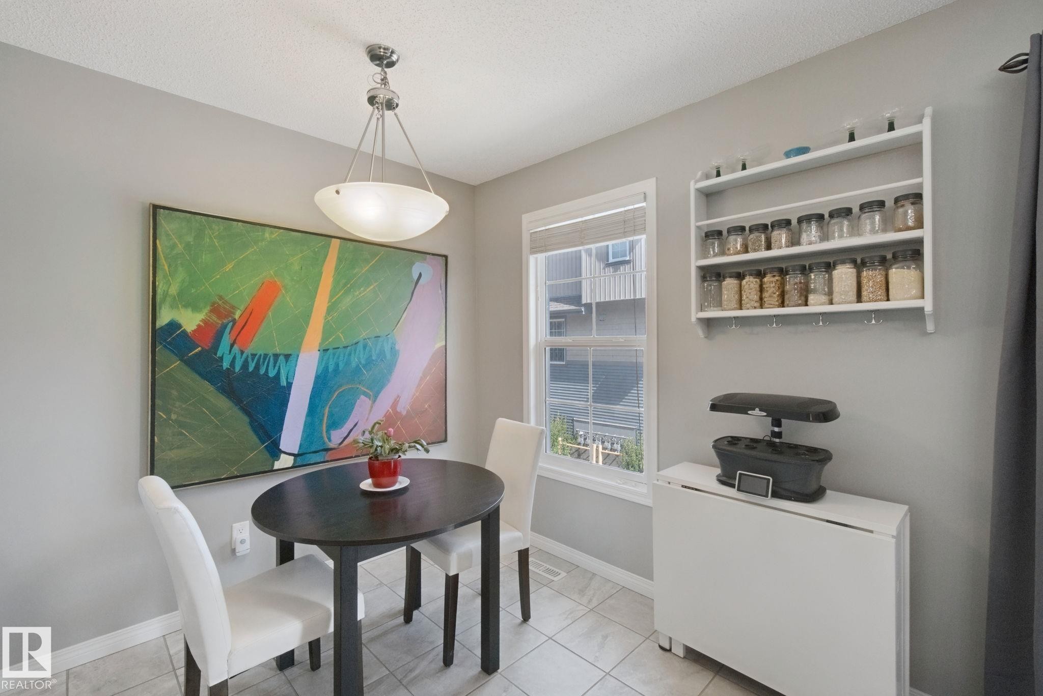 Recessed ceiling light fixture with a glass bowl shade, a white window frame, and a wall-mounted shelving unit - #58 4029 Orchards Dr Sw, Edmonton, AB