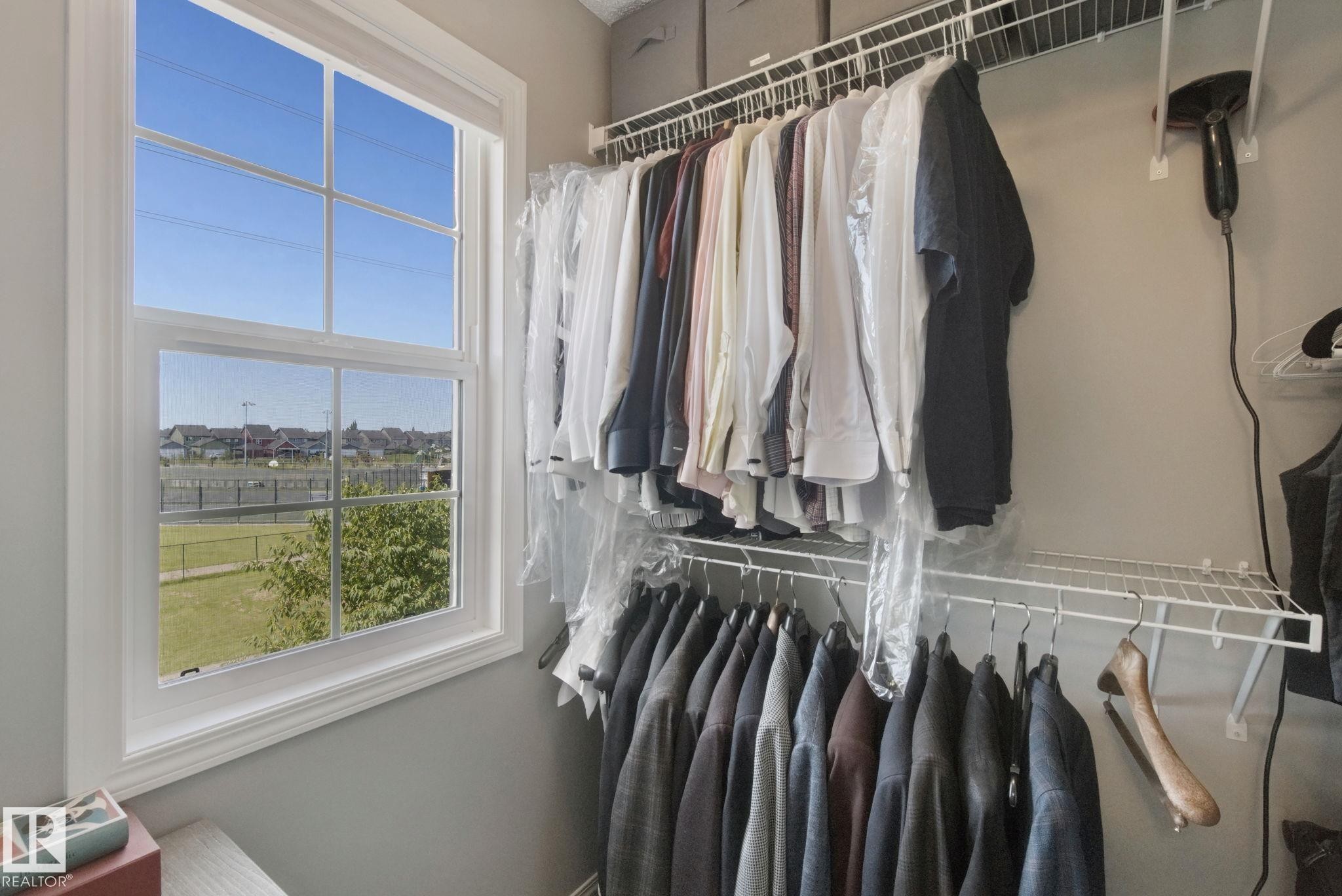 White-framed window with grid, offering natural light - #58 4029 Orchards Dr Sw, Edmonton, AB