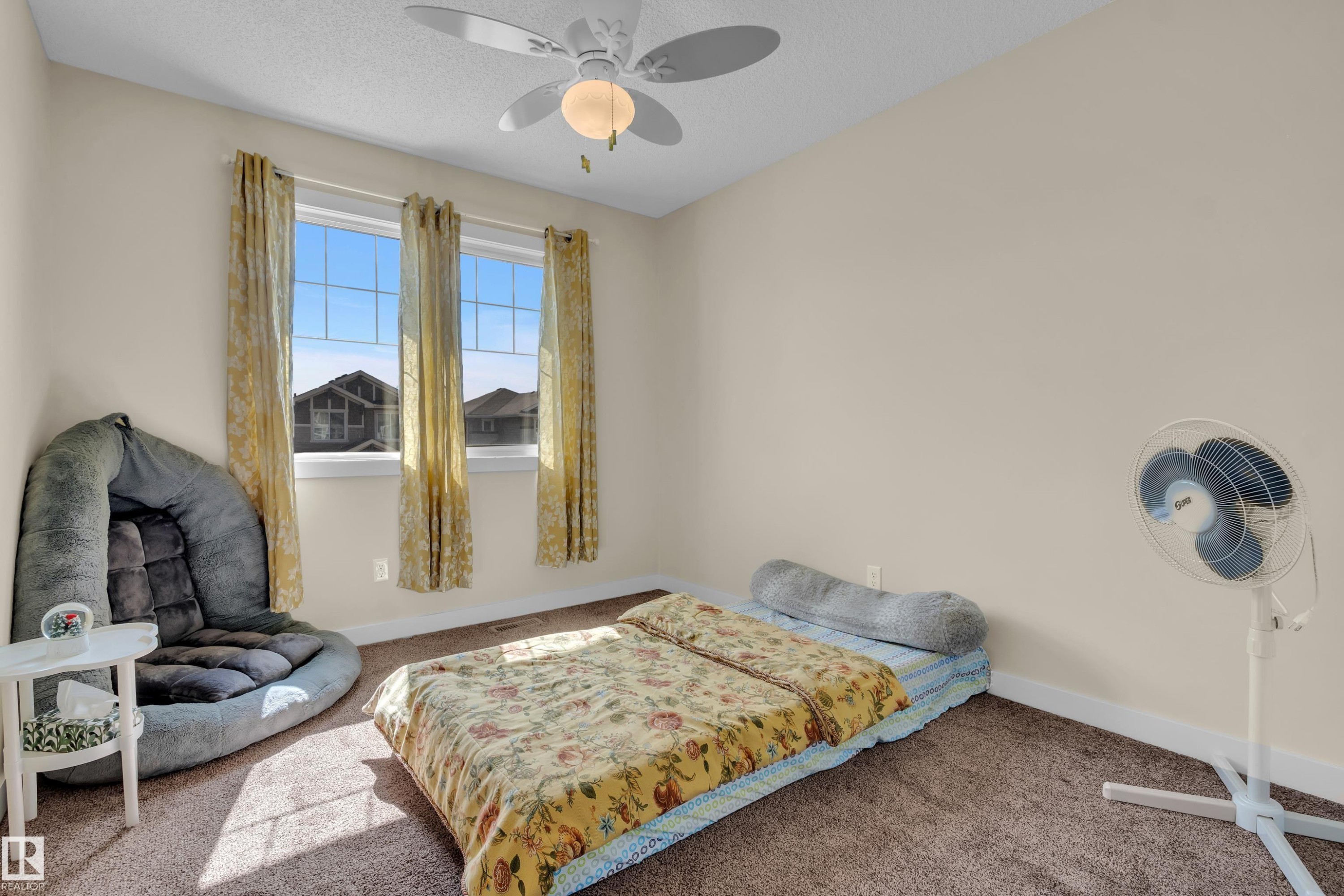 Room featuring neutral wall paint, a ceiling fan with integrated lighting, and carpet flooring - 3071 Carpenter Landing Sw, Edmonton, AB
