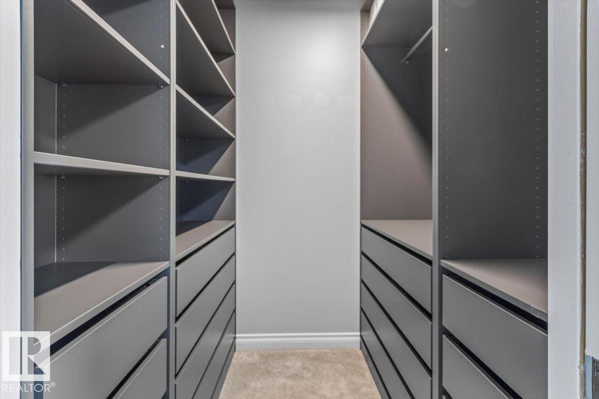 Built-in custom cabinetry featuring multiple shelving units and drawers - 15420 44 Street Nw, Edmonton, AB
