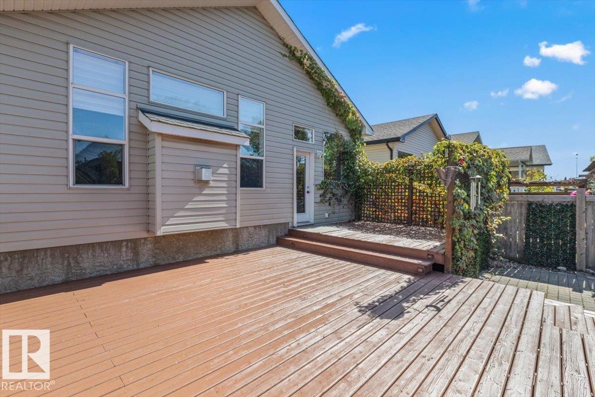 Expansive wood deck with tiered steps, providing access to the property - 15420 44 Street Nw, Edmonton, AB