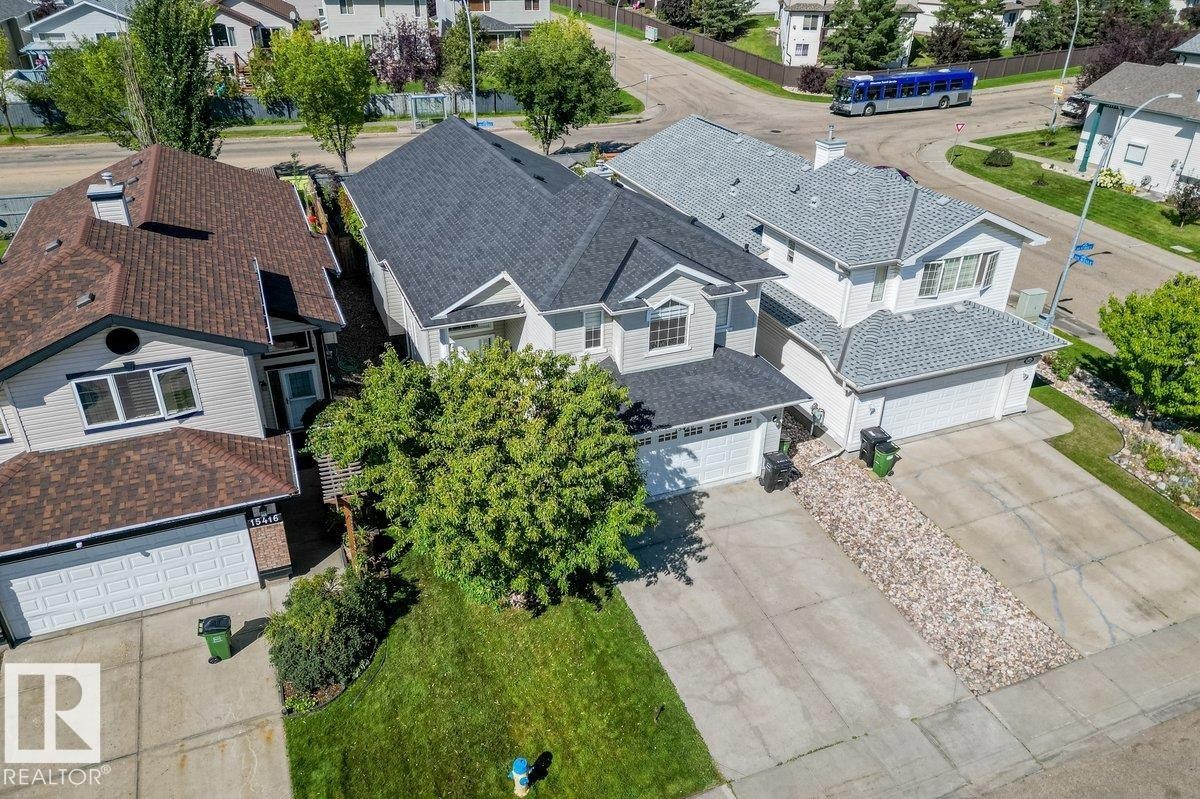 Two-story residential architecture featuring a gabled roof, attached garage, and concrete driveway - 15420 44 Street Nw, Edmonton, AB