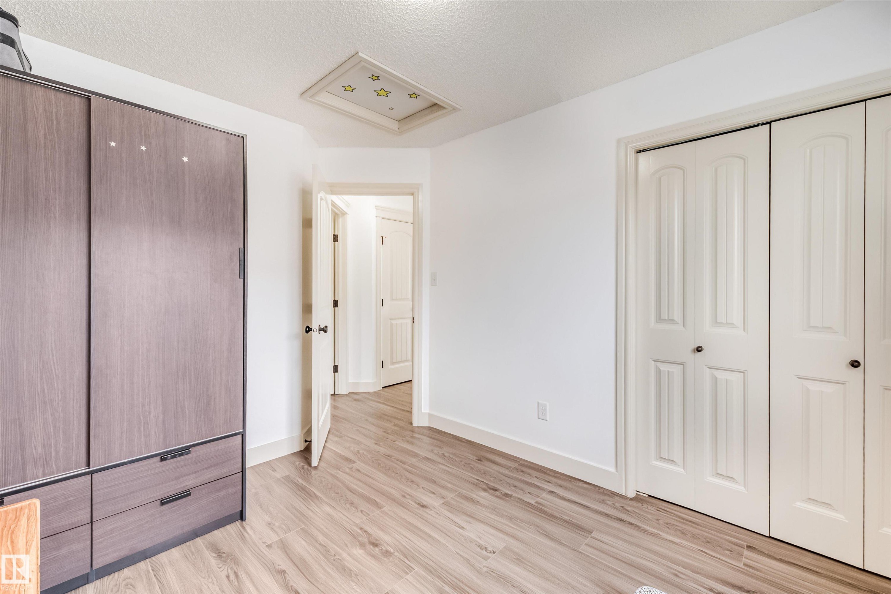 Wood-finish flooring, white walls, and a recessed ceiling feature - 20324 48 Avenue Nw, Edmonton, AB
