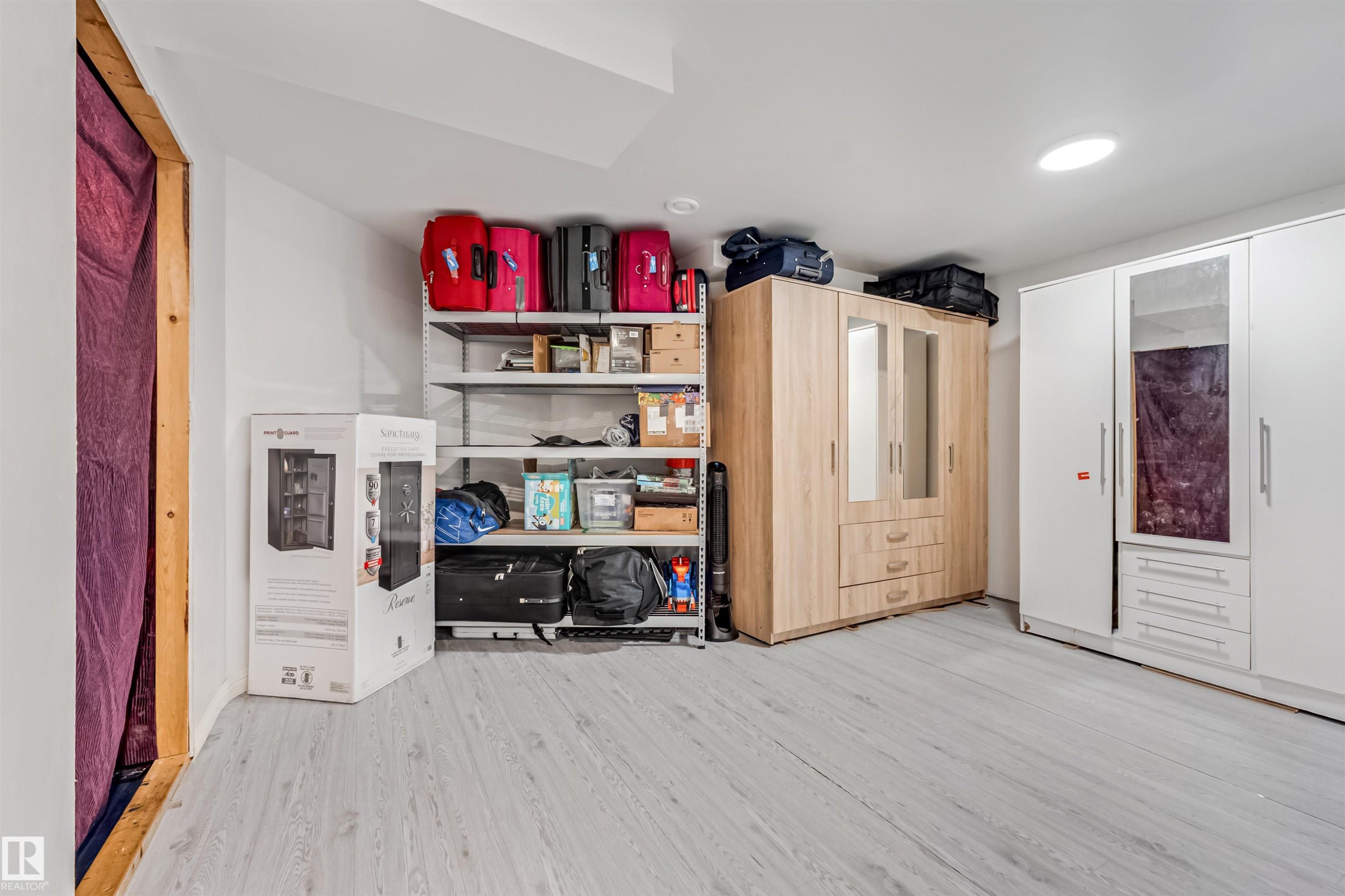 Wood-finish flooring with recessed ceiling lighting - 20324 48 Avenue Nw, Edmonton, AB