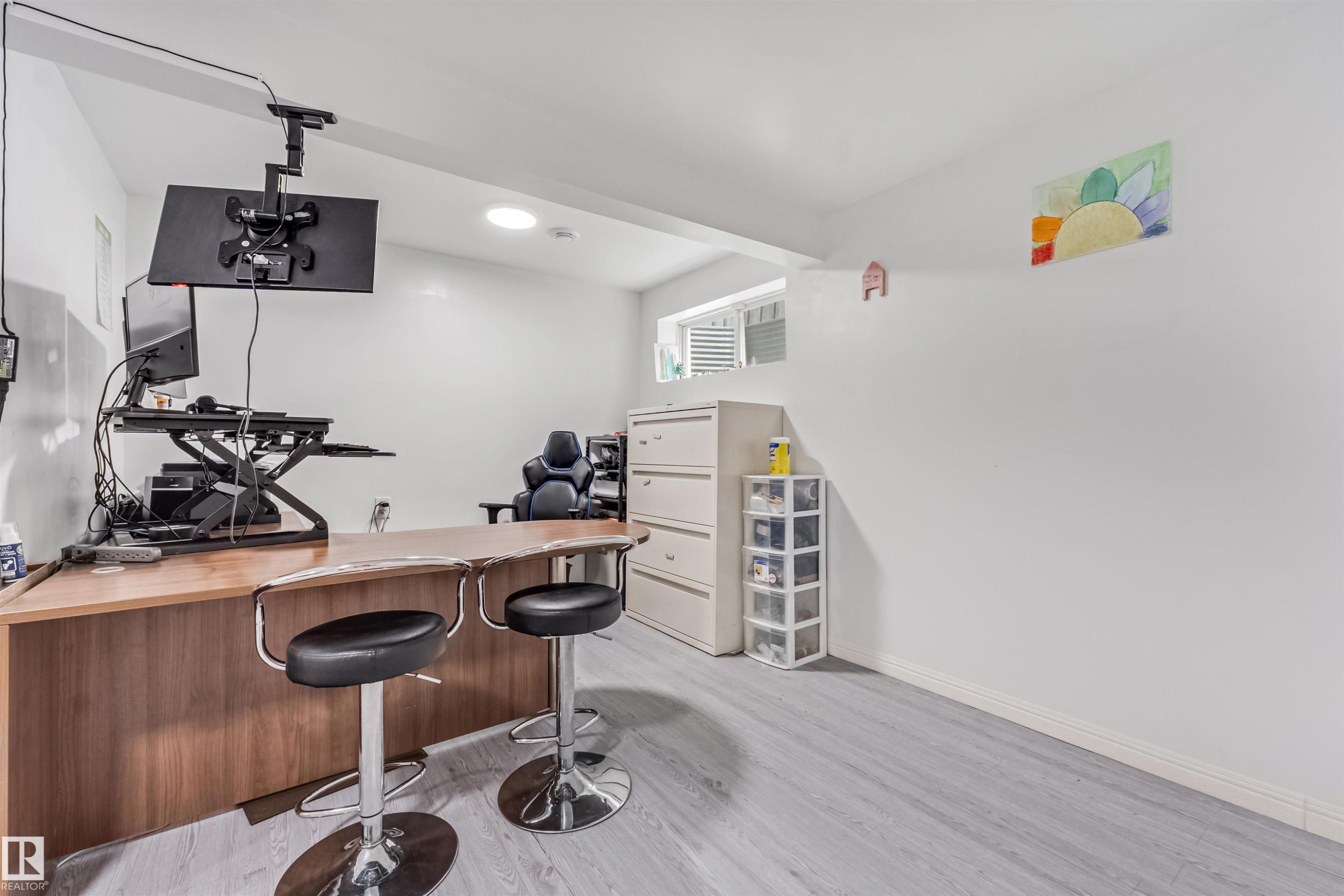 Light-toned wood-finish flooring, white painted walls, and a window with blinds - 20324 48 Avenue Nw, Edmonton, AB