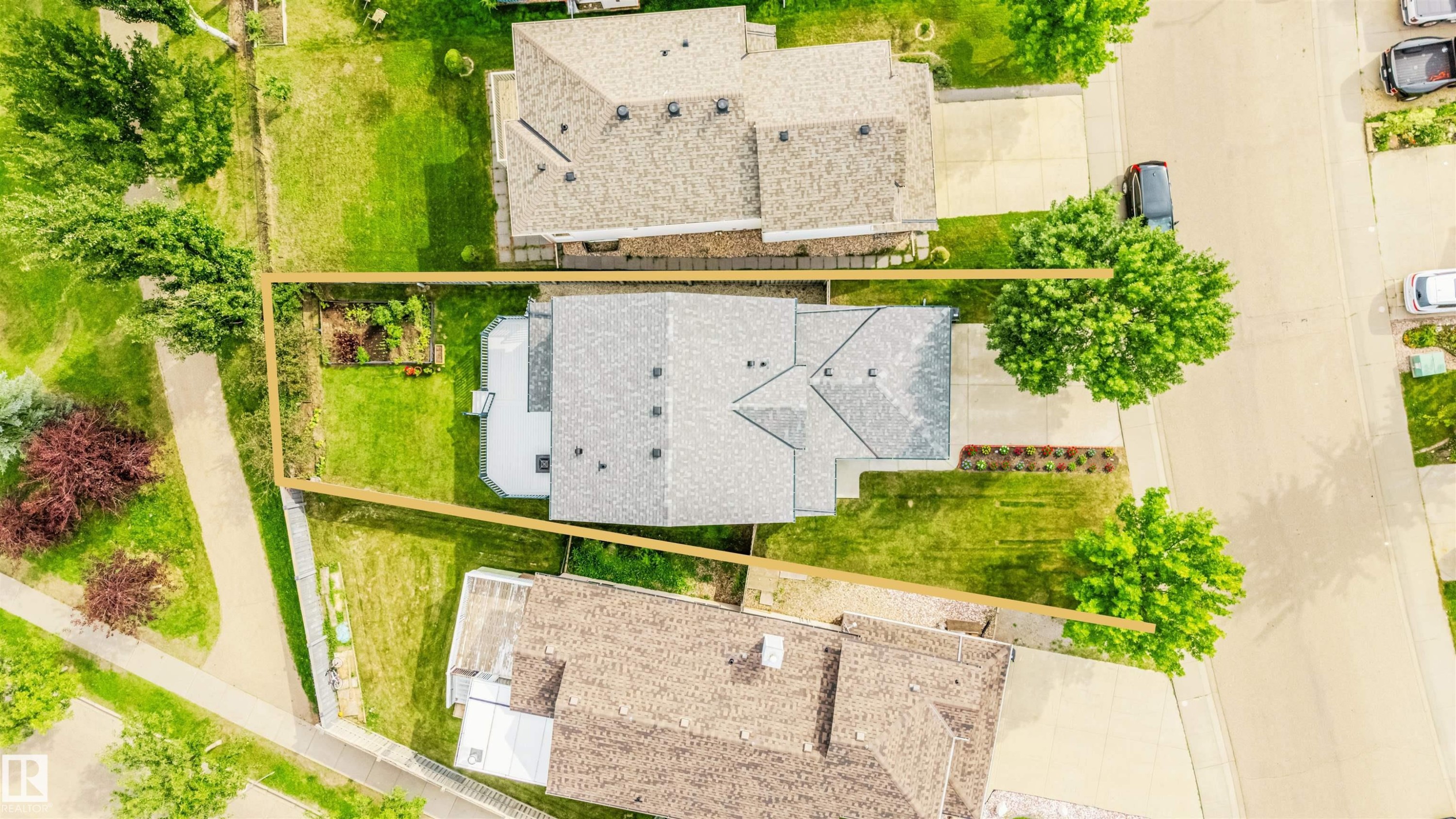 Expansive lot featuring a residential structure with a shingled roof, surrounding green spaces, and mature trees - 20324 48 Avenue Nw, Edmonton, AB