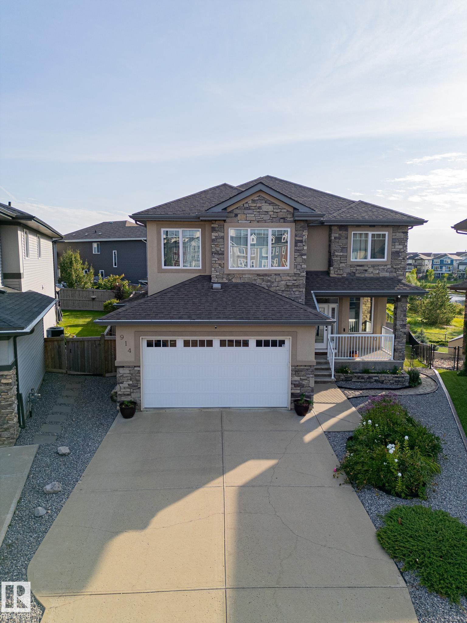 Stone and stucco exterior with multiple gables - 914 Crystallina Nera Way Nw, Edmonton, AB