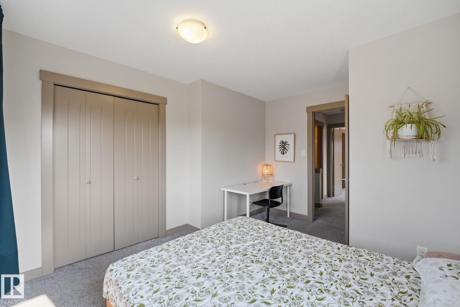 Recessed closet with bifold doors, neutral paint palette, and overhead flush-mount lighting - 17621 10 Avenue Sw, Edmonton, AB - Indoor Photo Showing Bedroom