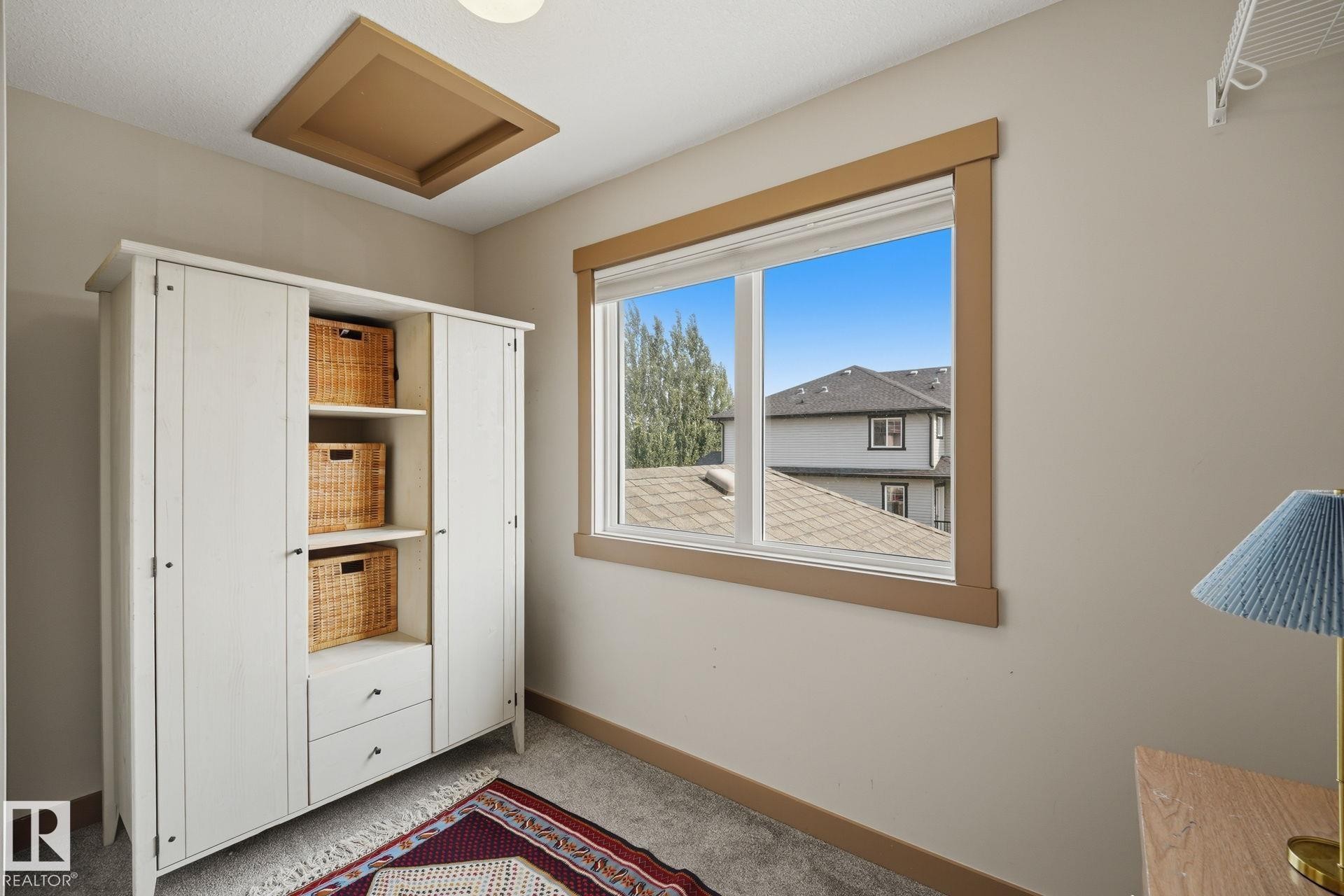spacious walk-in closet with a large window for natural light - 17621 10 Avenue Sw, Edmonton, AB - Indoor Photo Showing Other Room