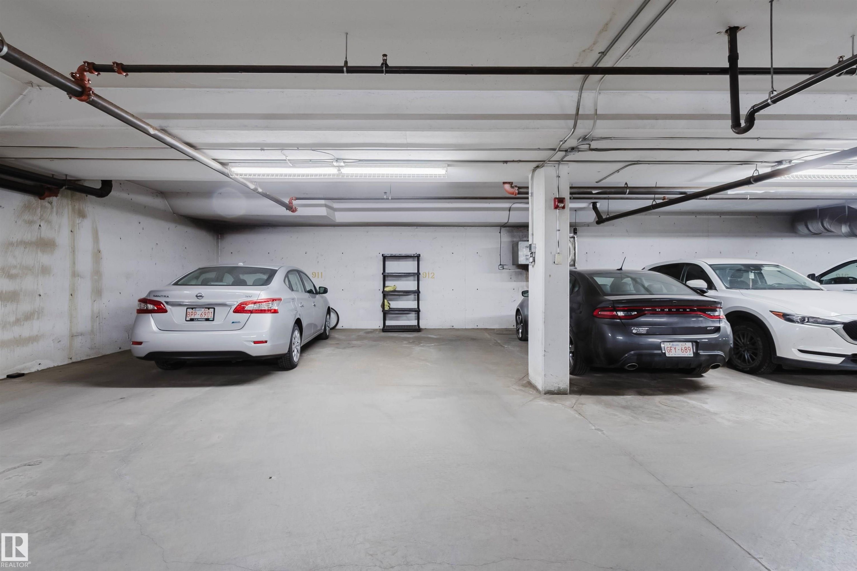 Concrete flooring and walls with overhead lighting, exposed ceiling pipes, and structural columns - #7428 7327 South Terwillegar Dr Nw, Edmonton, AB
