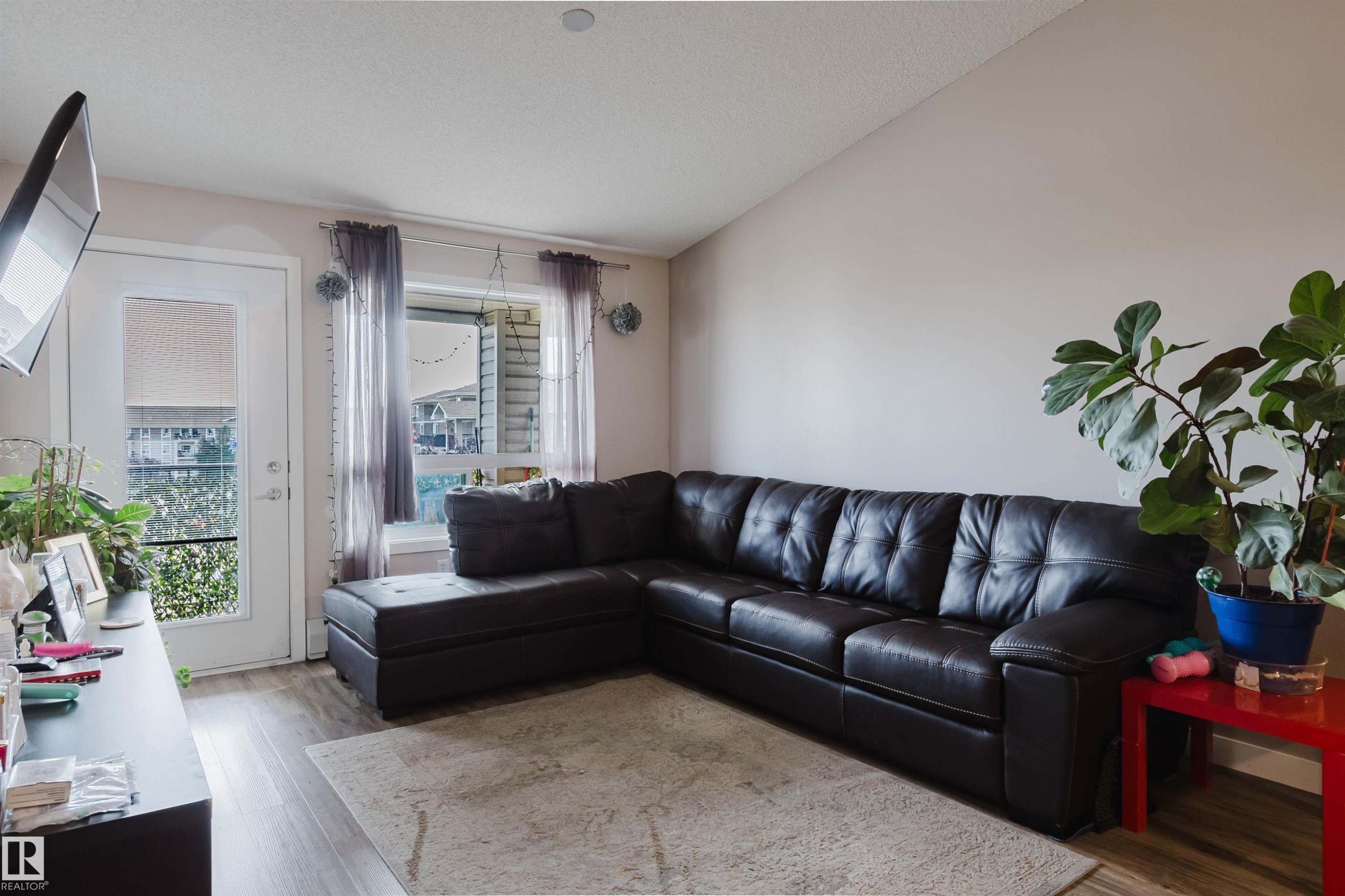Vaulted ceiling, wood-finish flooring, white door with glass panel, recessed lighting, and window with exterior view - #7428 7327 South Terwillegar Dr Nw, Edmonton, AB