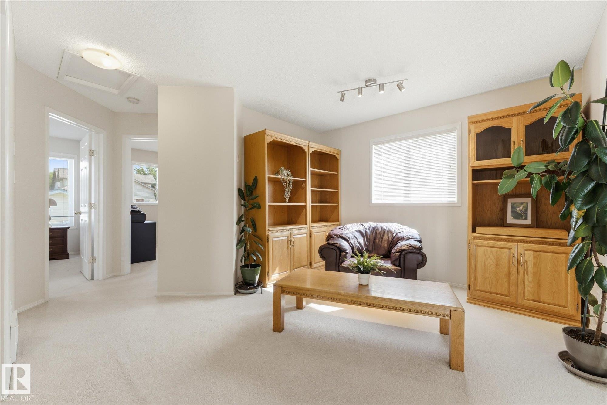 Carpeted flooring, recessed lighting, track lighting, built-in shelving, and a window with blinds - 1709 Turvey Bend Bend Nw, Edmonton, AB