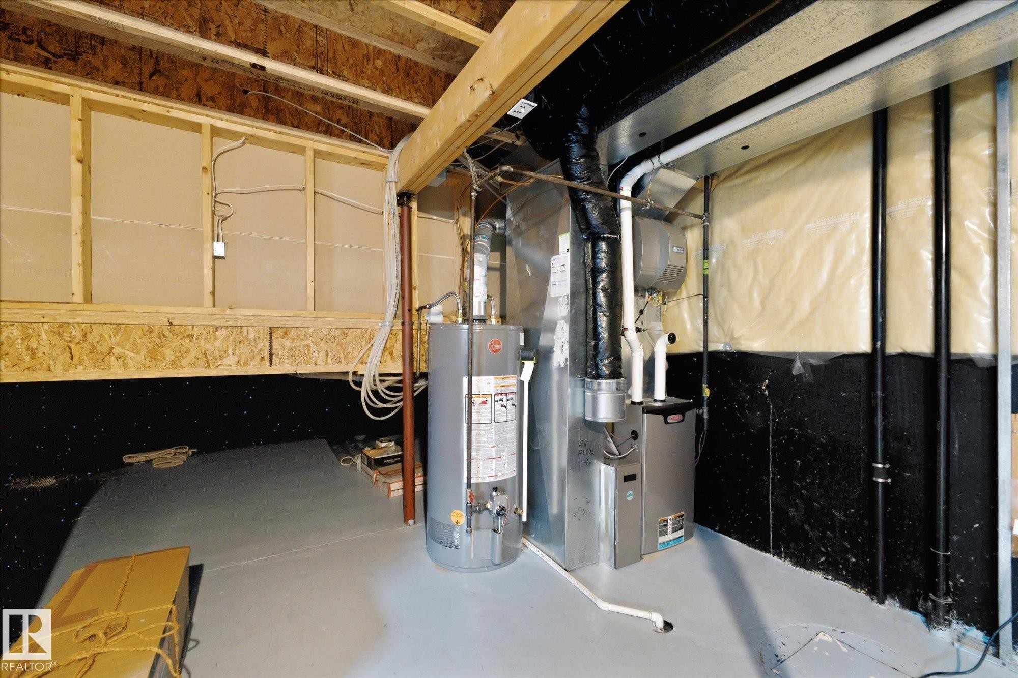 Unfinished basement with exposed wood framing, concrete flooring, and visible utility systems - 1709 Turvey Bend Bend Nw, Edmonton, AB
