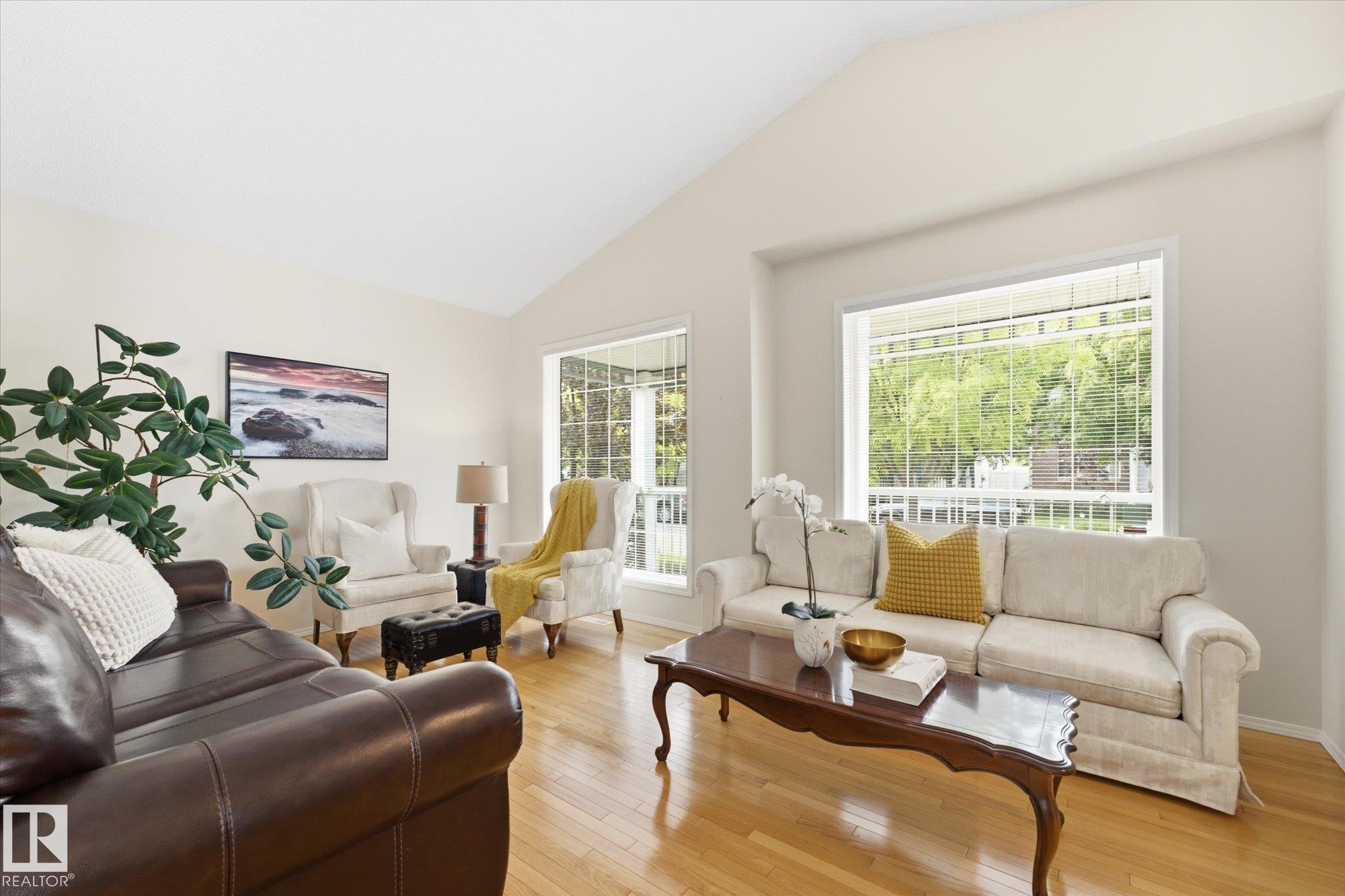 Vaulted ceiling, wood-finish flooring, large windows, white walls, and a decorative trim window - 1709 Turvey Bend Bend Nw, Edmonton, AB