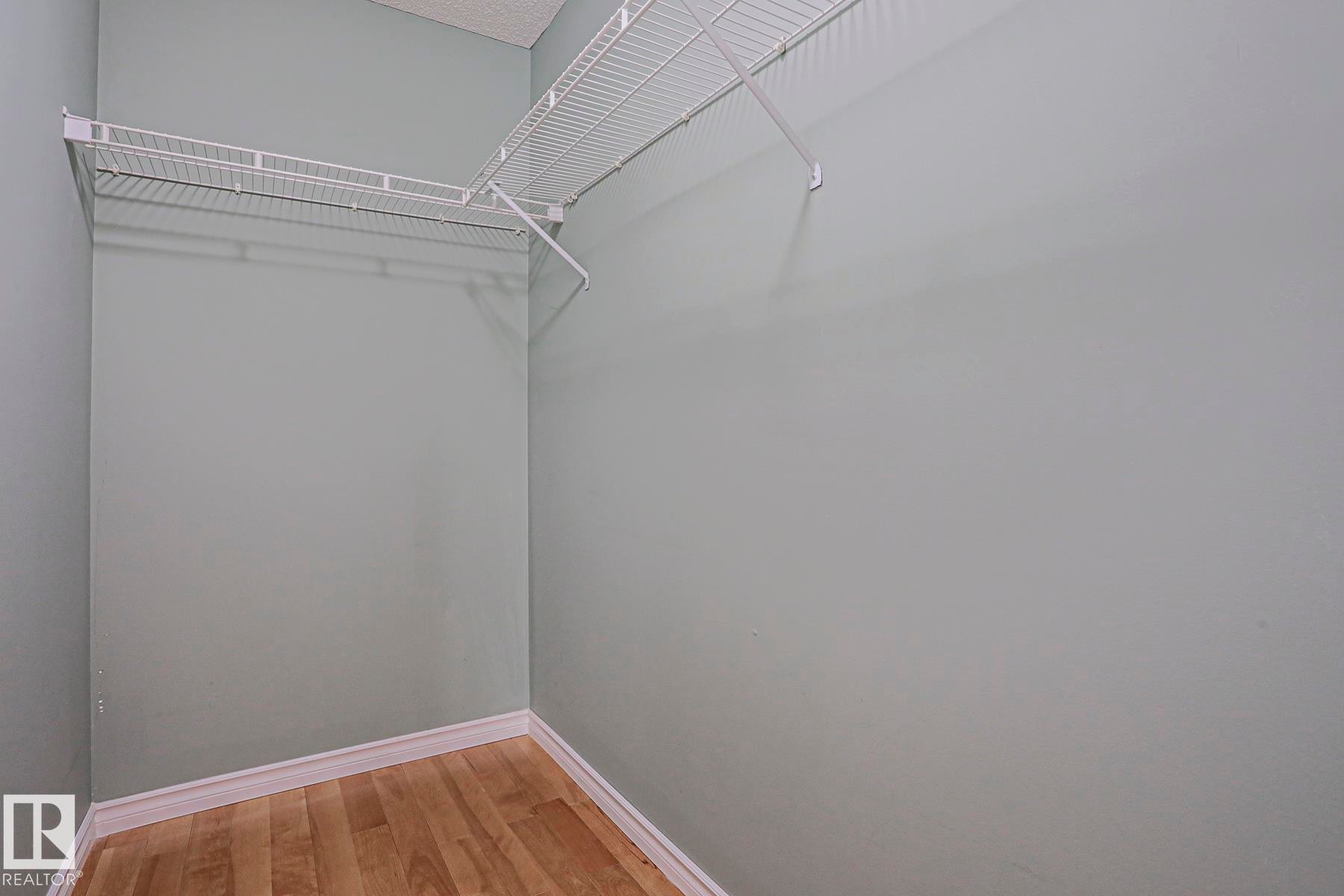L-shaped wire shelving system with light-toned wood-finish flooring - 15031 135 Street Nw, Edmonton, AB