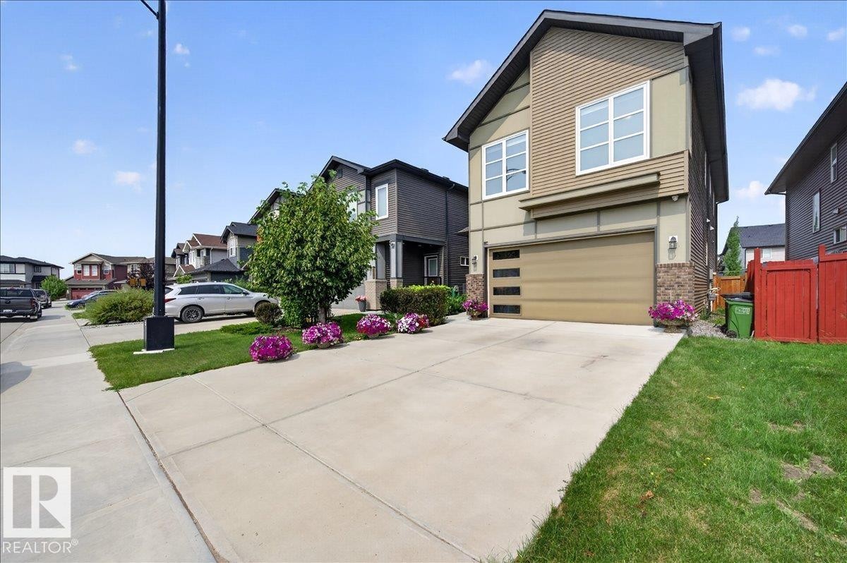 Contemporary exterior with tan siding and stone accents - 2709 Collins Crescent Sw, Edmonton, AB - Outdoor With Facade