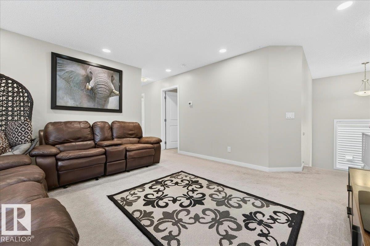 Spacious room featuring neutral carpeting and light gray walls - 2709 Collins Crescent Sw, Edmonton, AB - Indoor Photo Showing Other Room