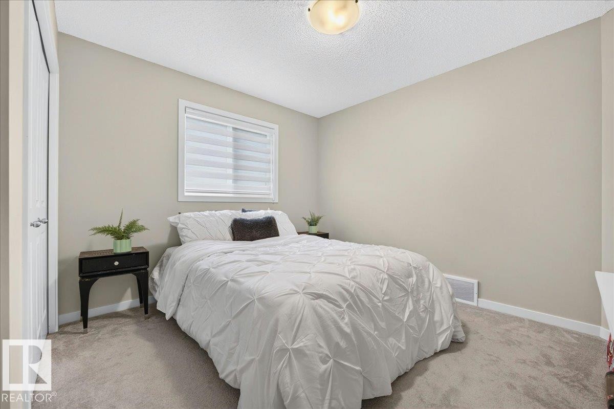 Neutral-toned walls complement plush carpeting - 2709 Collins Crescent Sw, Edmonton, AB - Indoor Photo Showing Bedroom