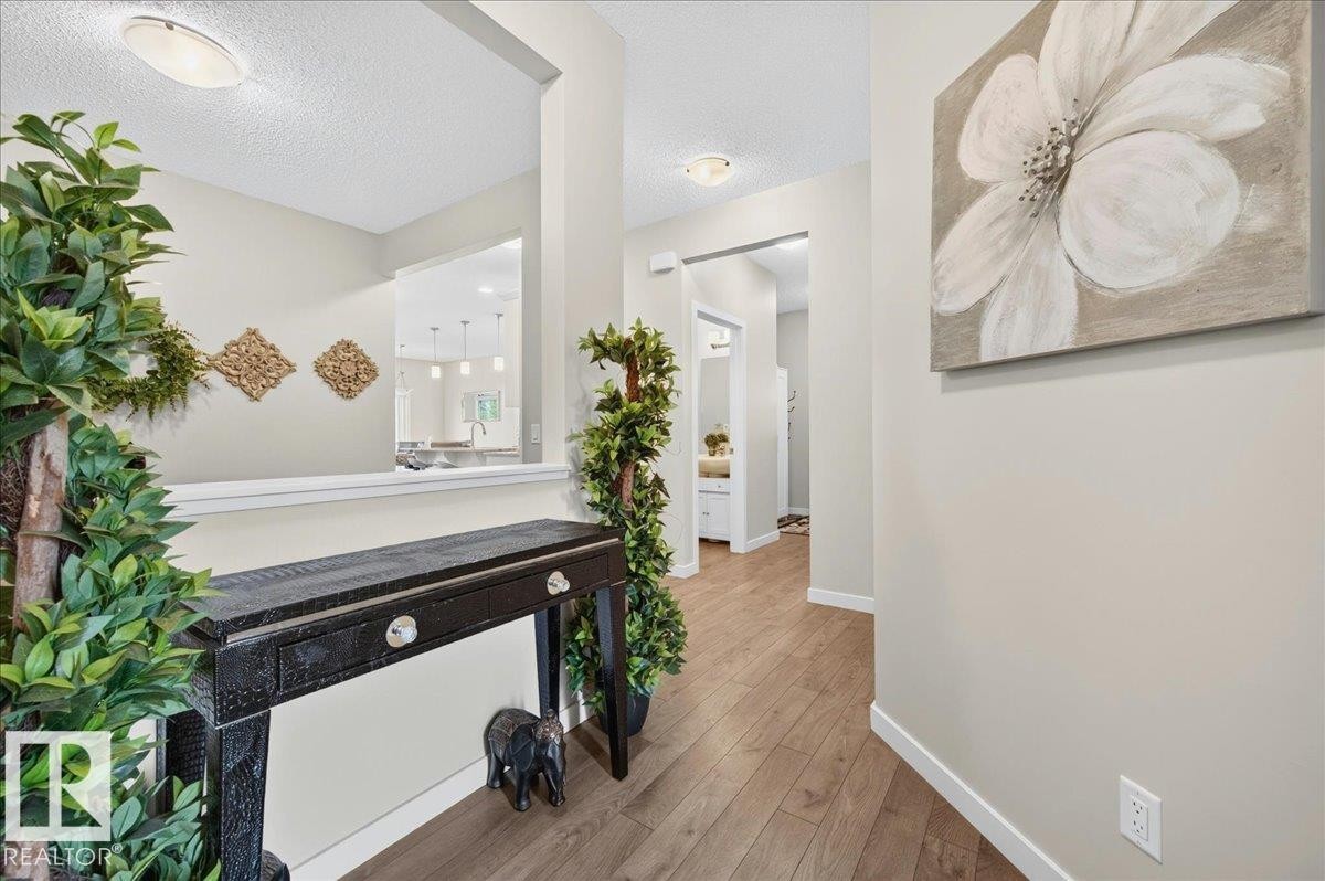 Entryway featuring wood-finish flooring, neutral wall paint, and white trim - 2709 Collins Crescent Sw, Edmonton, AB - Indoor Photo Showing Other Room