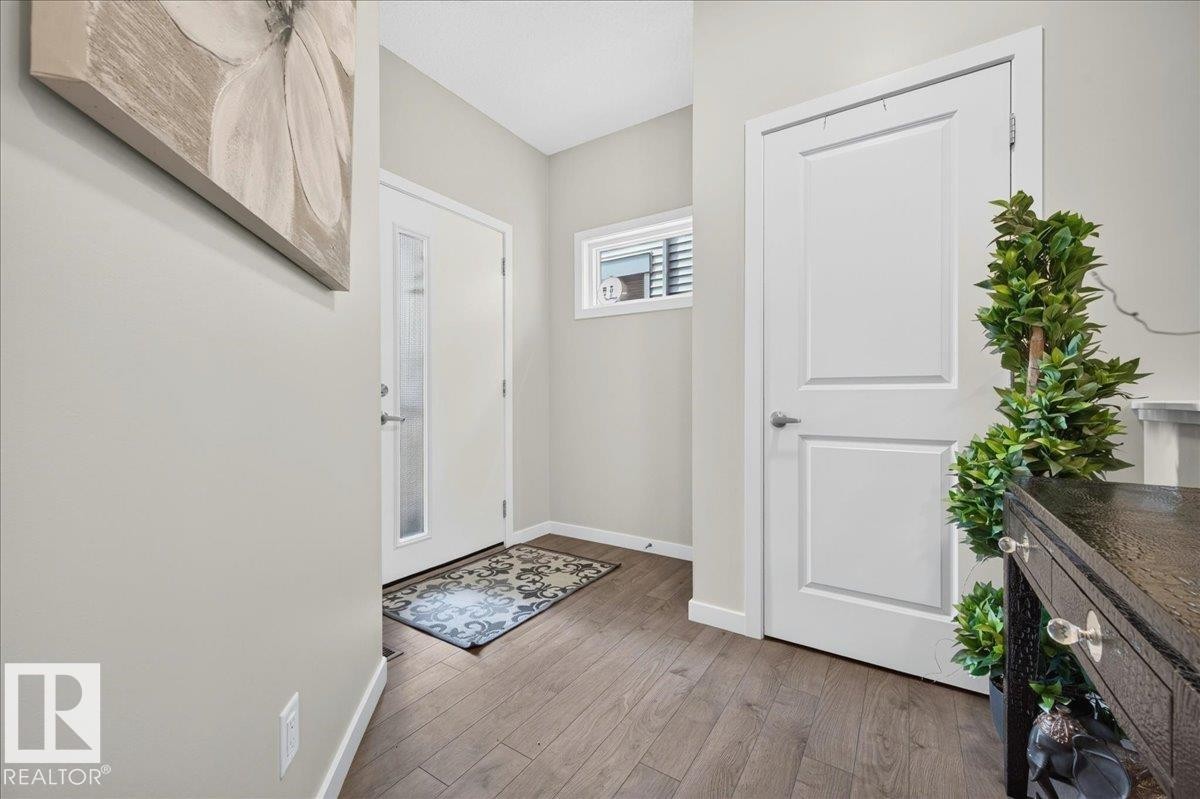 Entryway featuring wood-finish flooring, light grey walls, and white trim - 2709 Collins Crescent Sw, Edmonton, AB - Indoor Photo Showing Other Room