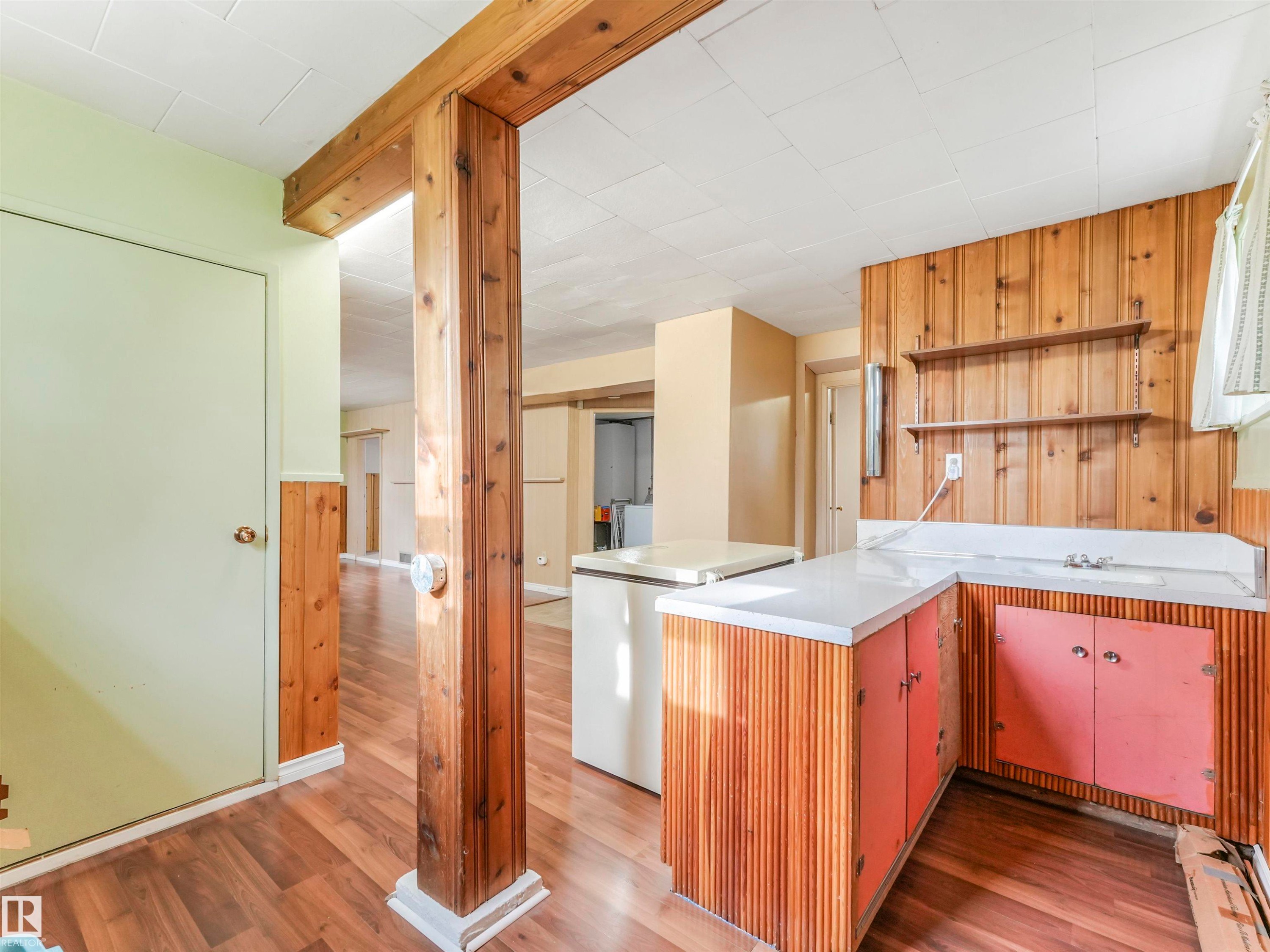 Wood-finish flooring with wood paneling accents - 12614 69 Street Nw, Edmonton, AB